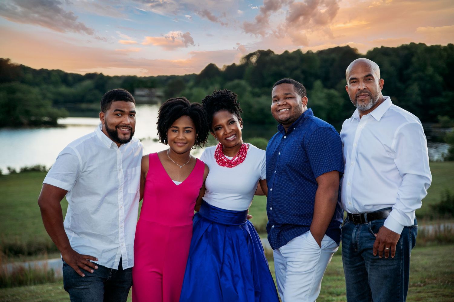 Group photo of people wearing coordinated white and blue outfits at sunset.