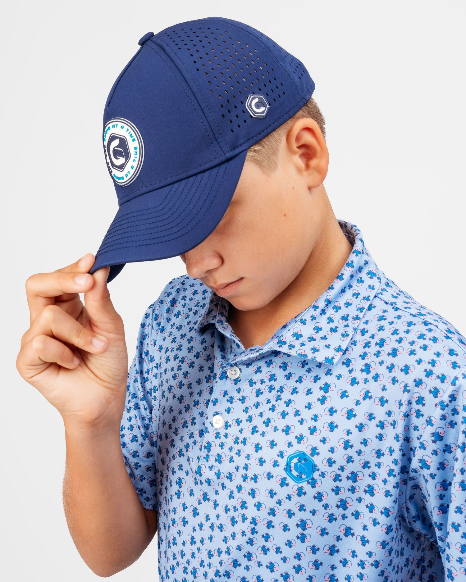 Close-up shots of a person wearing a blue baseball cap and floral print shirt.
