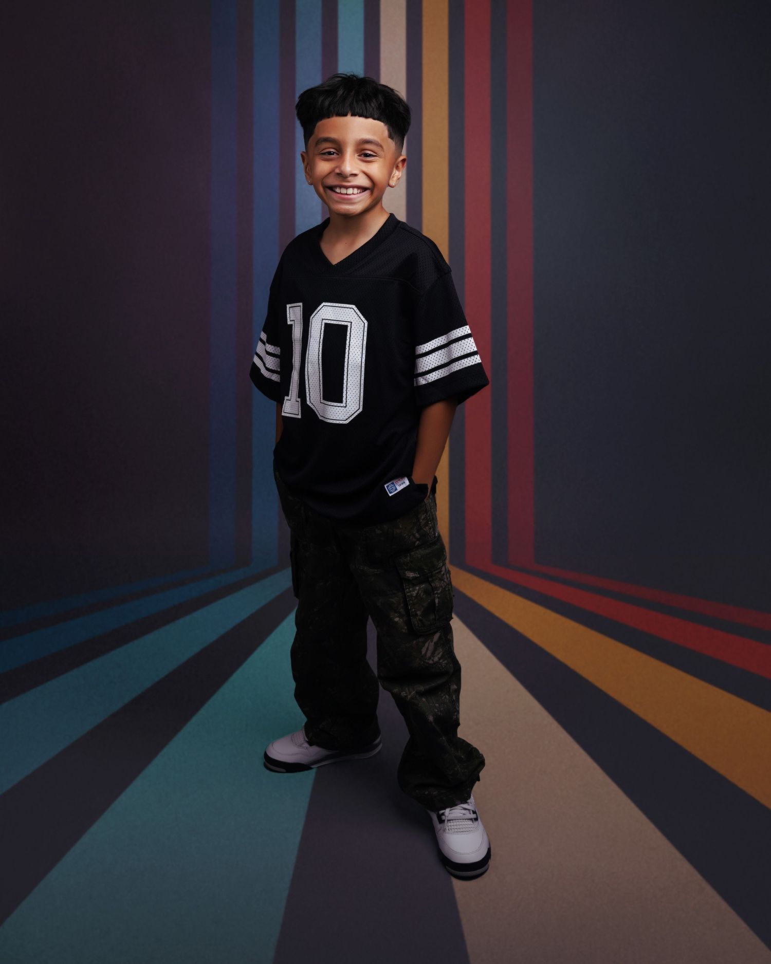 Stylish portrait series with colorful striped background and urban streetwear.