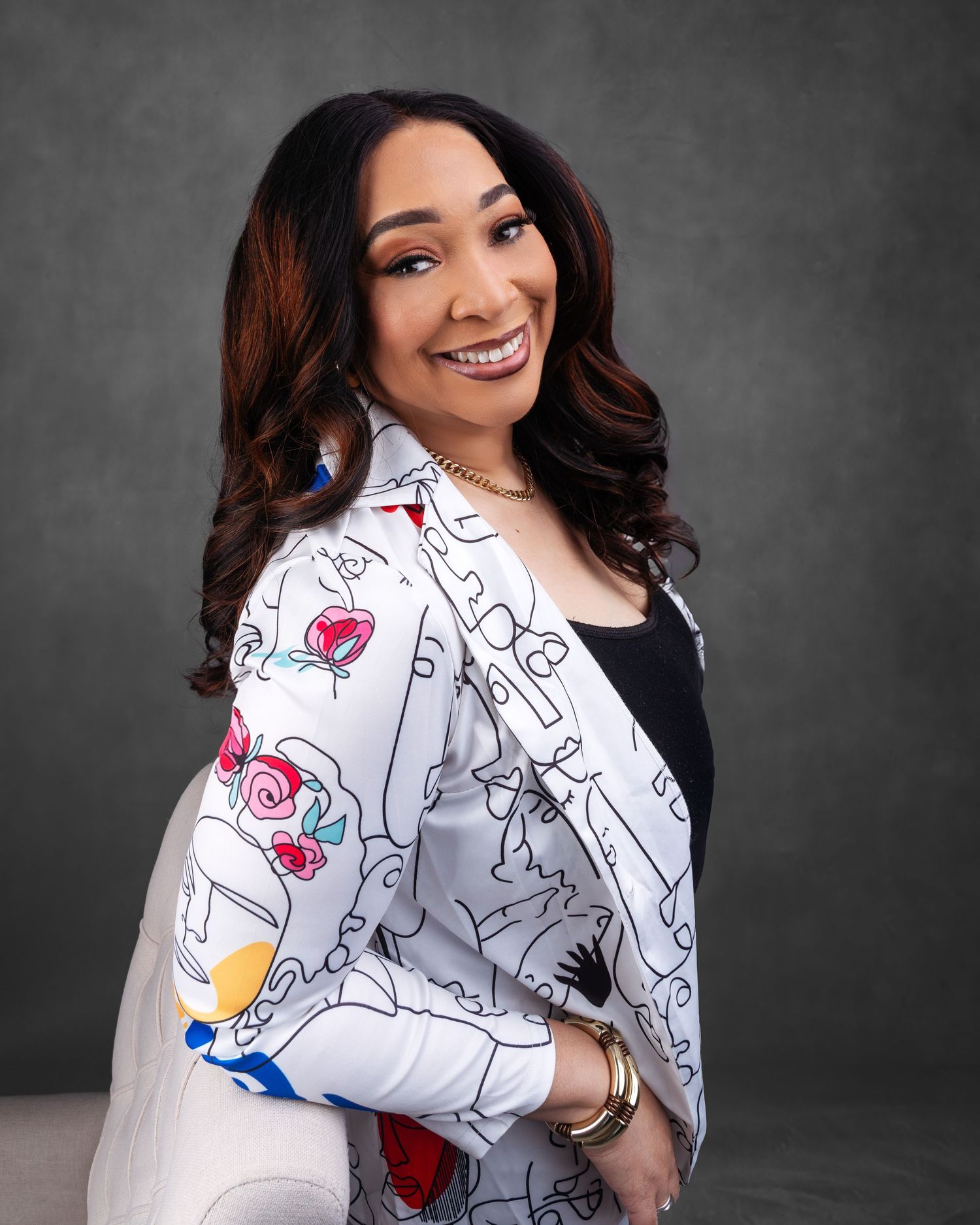 Studio portraits featuring person in white jacket with colorful cartoon print design.