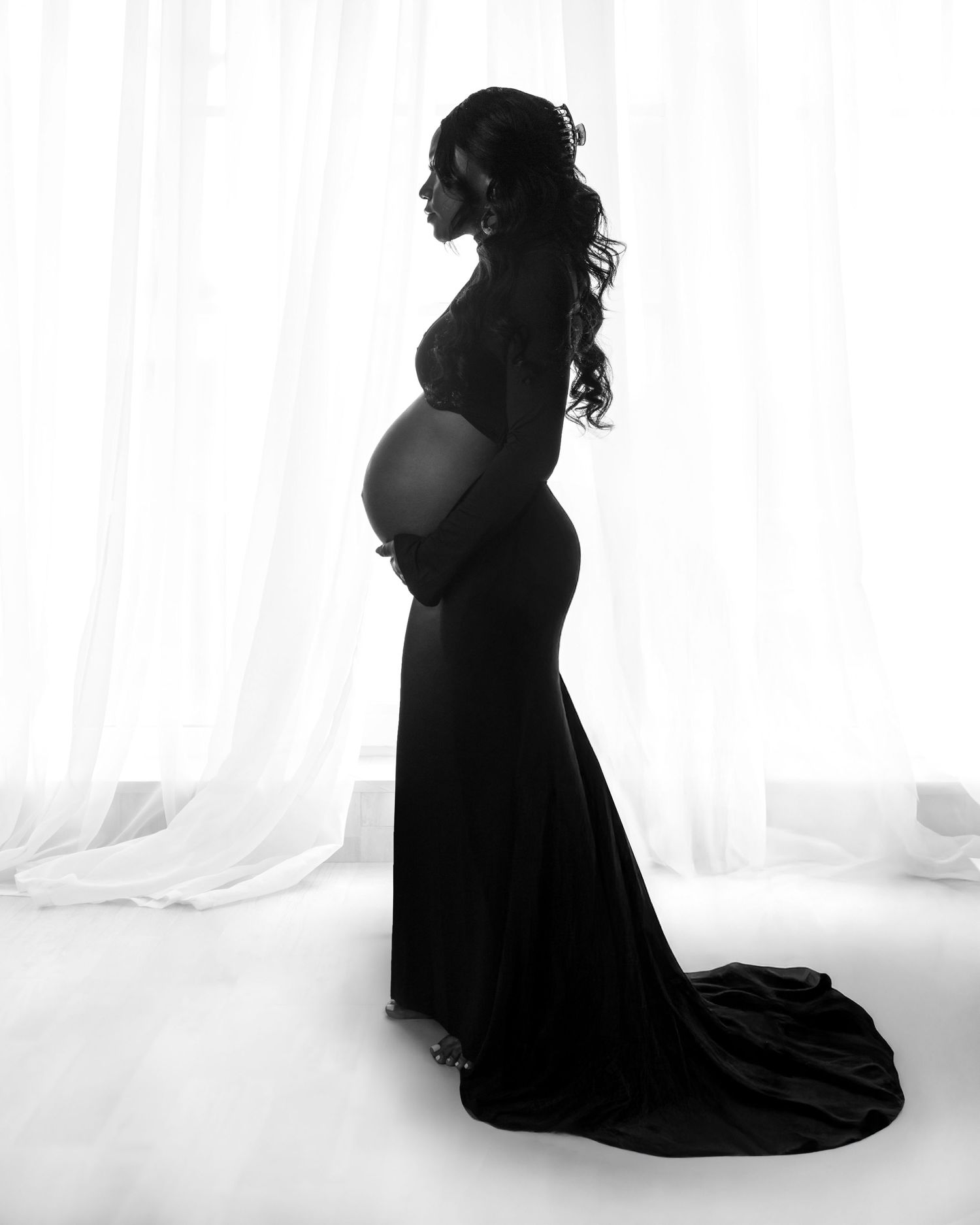Artistic silhouette portraits in black dress against white background showing dramatic poses.