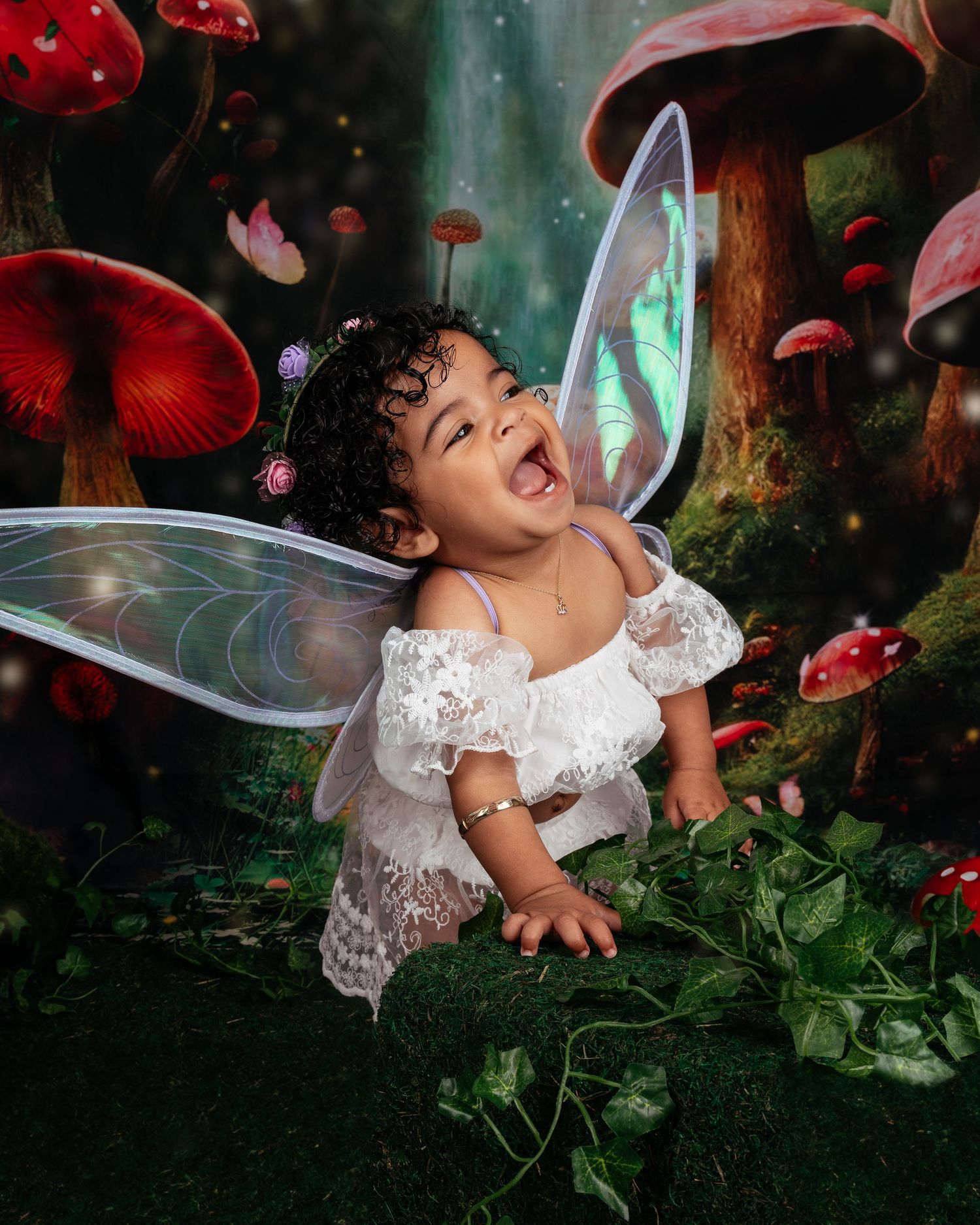 Whimsical fairy-themed photo with wings and mushrooms in an enchanted forest setting.