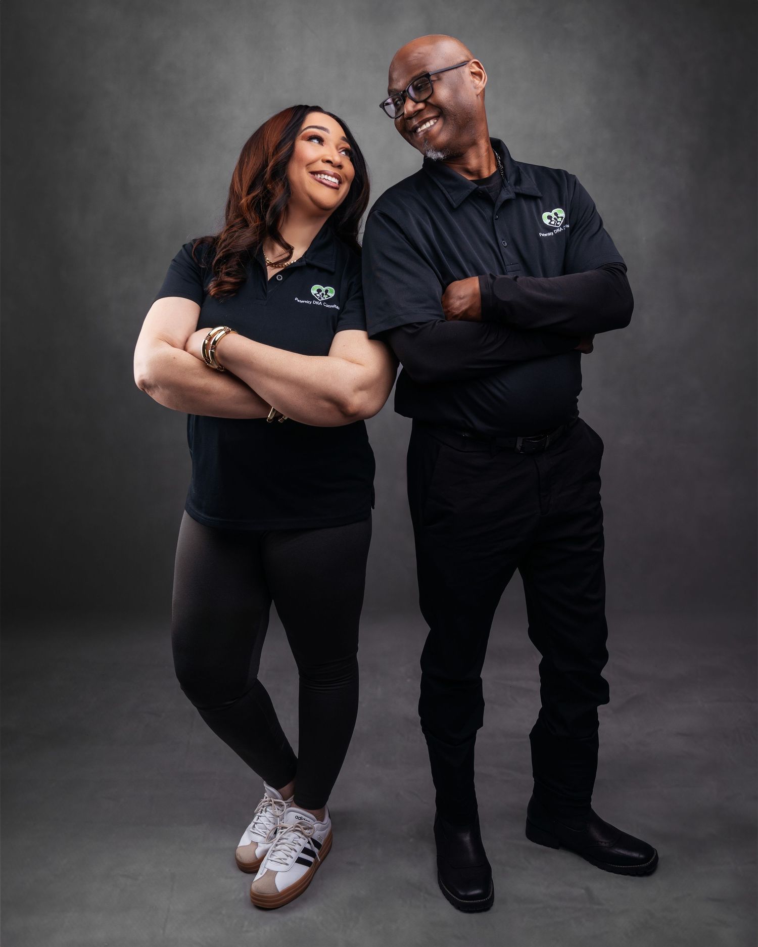 Professional business portrait session showing team members in matching black attire.