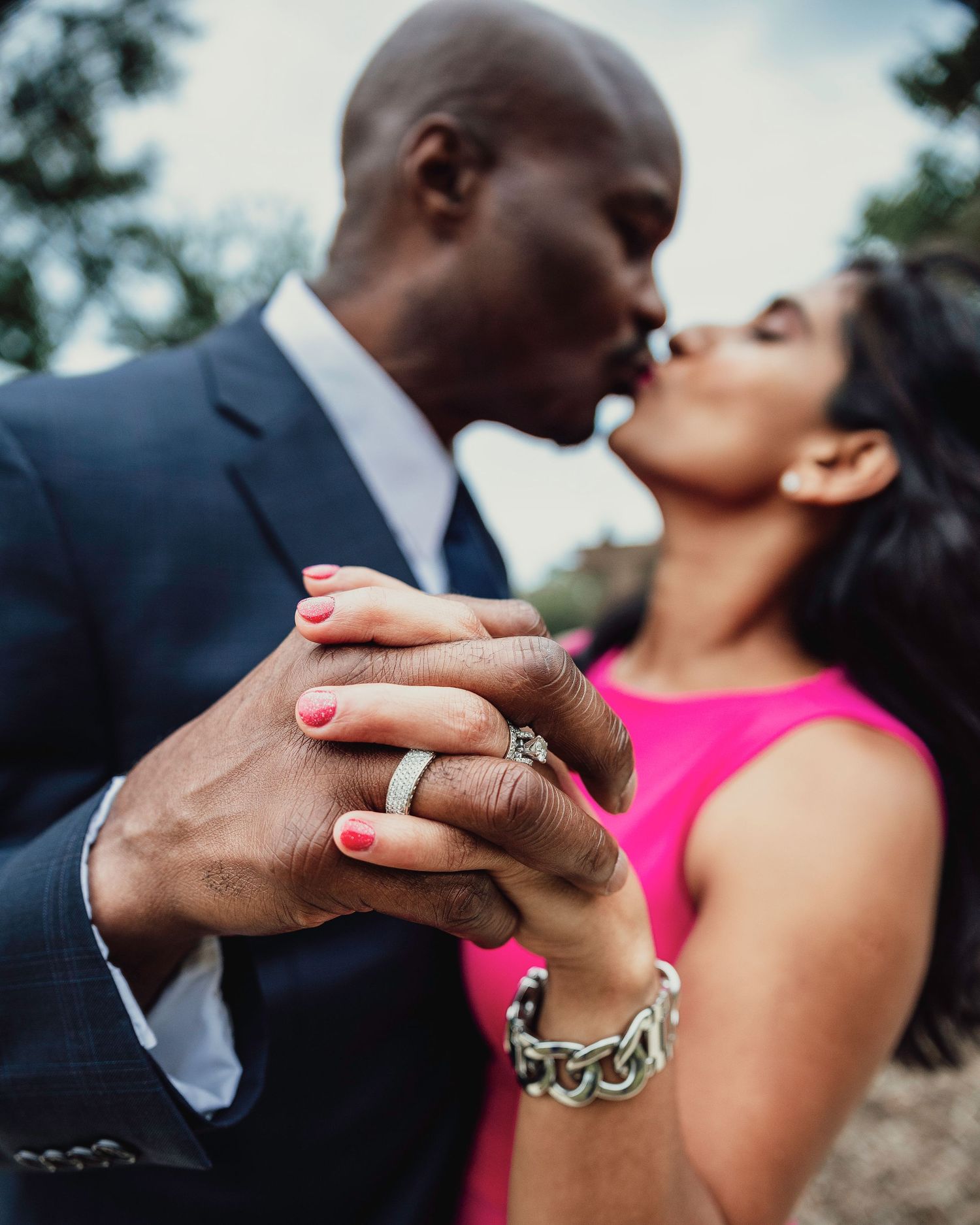 Close-up series showing hands with engagement ring and jewelry details during a romantic outdoor moment.