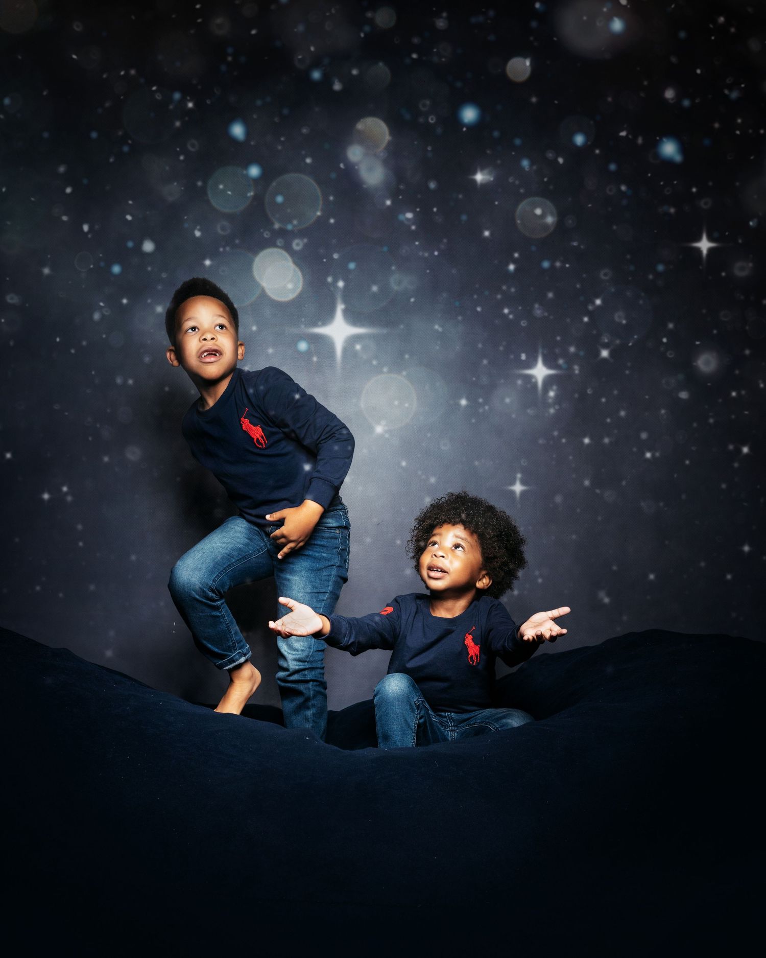 Whimsical nighttime photo shoot with starry backdrop and dramatic lighting.