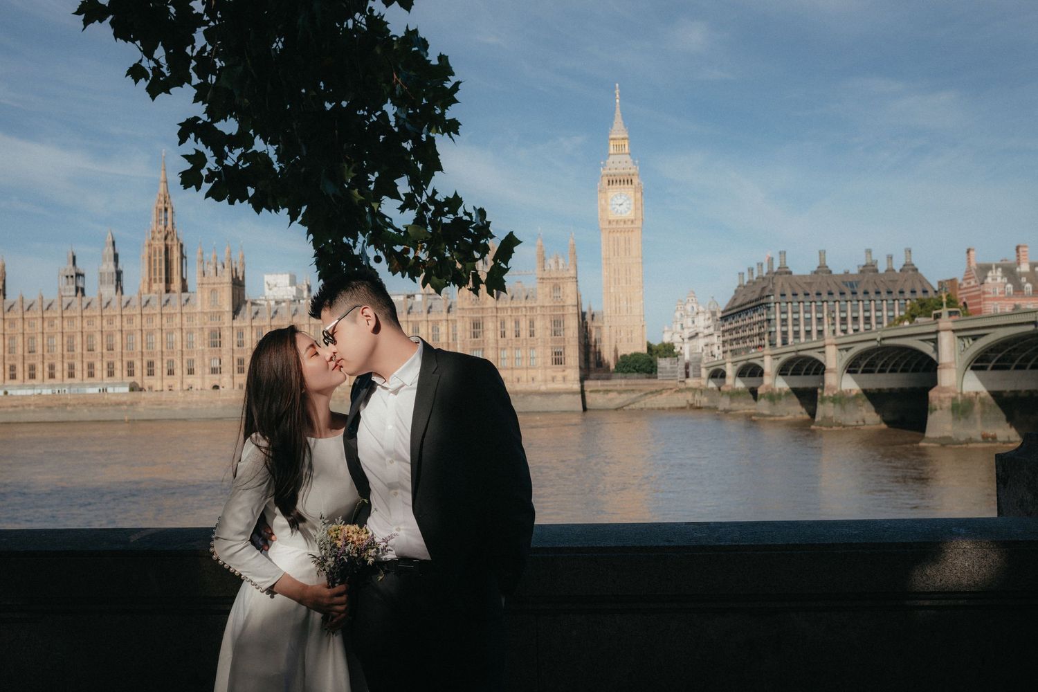 Panoramic wedding photo with London's Houses of Parliament and Thames River in the background.