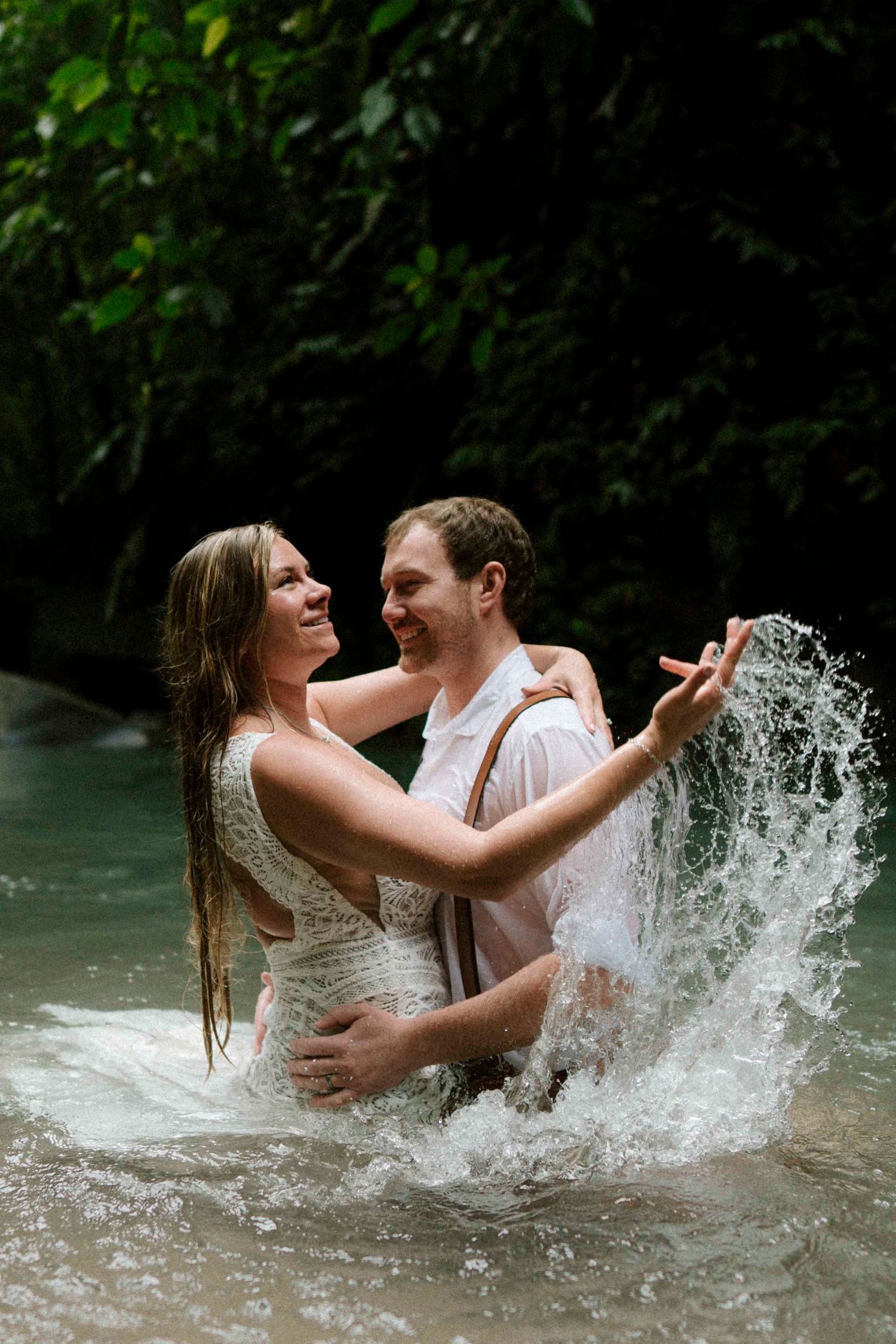 a couple enjoying the waterfall in costa rica