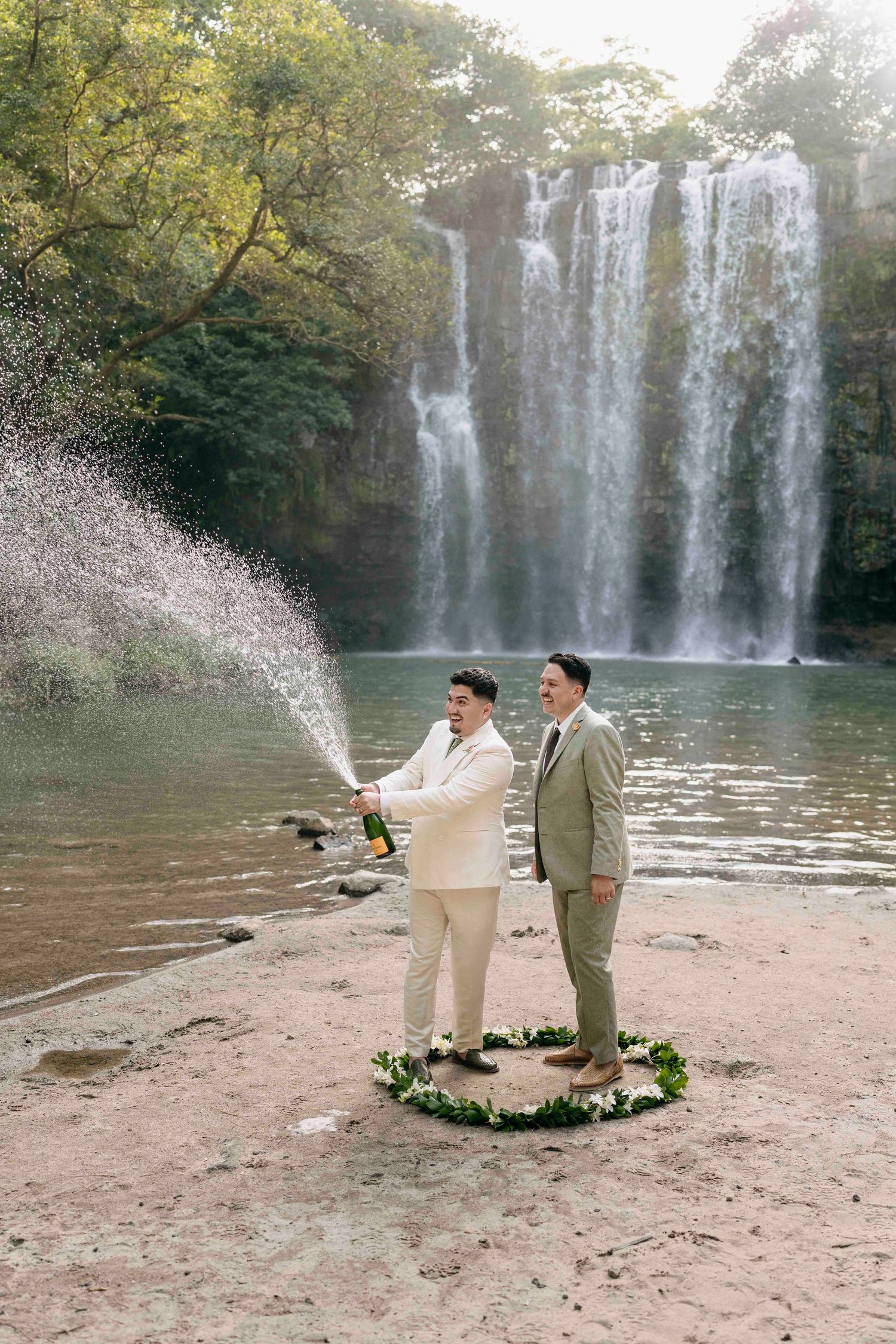 champagne toast in front of a waterfall in costa rica