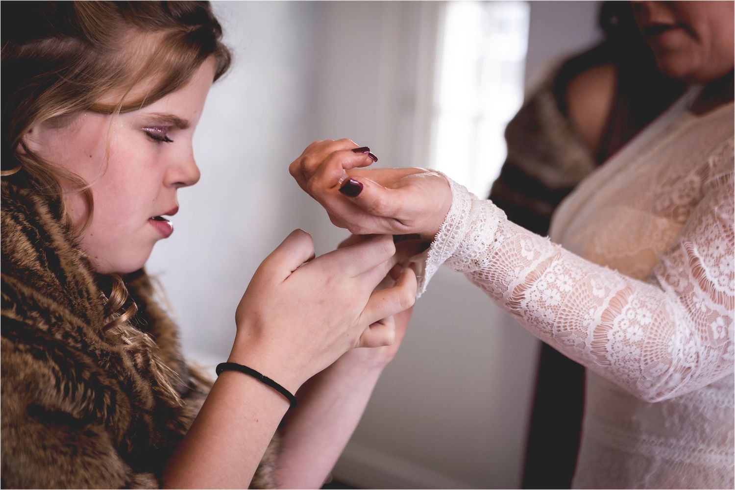 A bride holding her father's hand as they prepare to walk down the aisle in an emotional wedding moment.