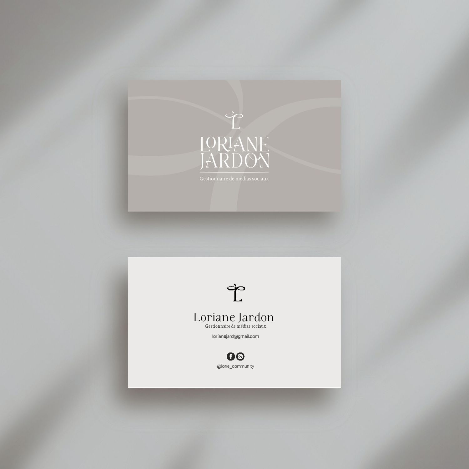 Elegant minimalist business cards with Loriane Jardon branding in soft gray tones.
