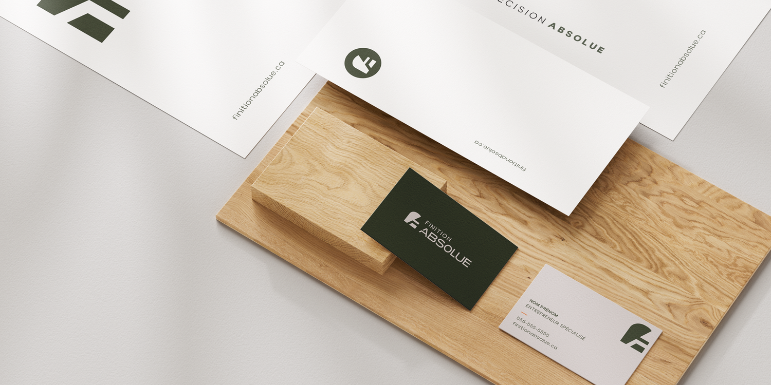 Minimalist branding mockup featuring business cards and stationery on a light wood surface.