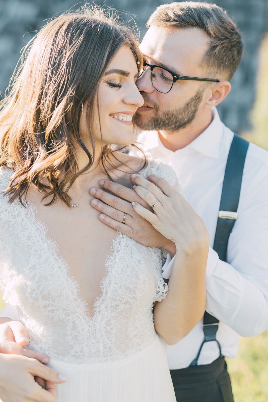 Romantic wedding couple shares intimate moments in a series of tender close-up portraits outdoors.
