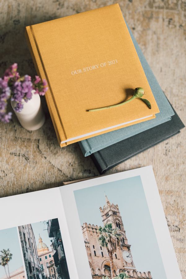 A series of wedding photo album pages showing yellow book covers and architectural photos of European churches and buildings.