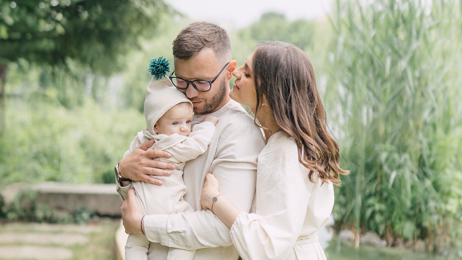 Family portrait series outdoors with natural foliage backdrop.