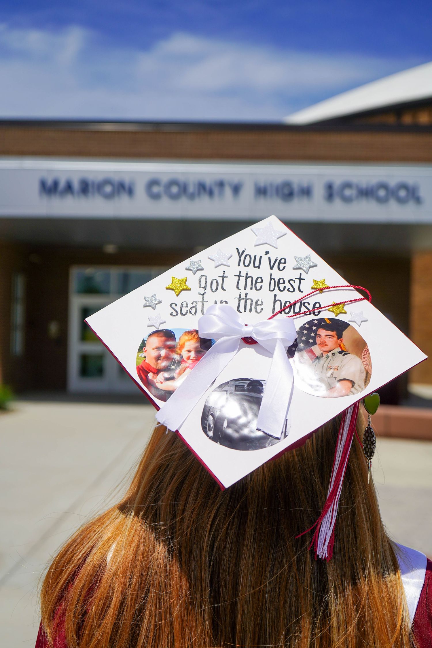Graduate at Marion County High School with decorated cap reading You've got the best seat in the house.