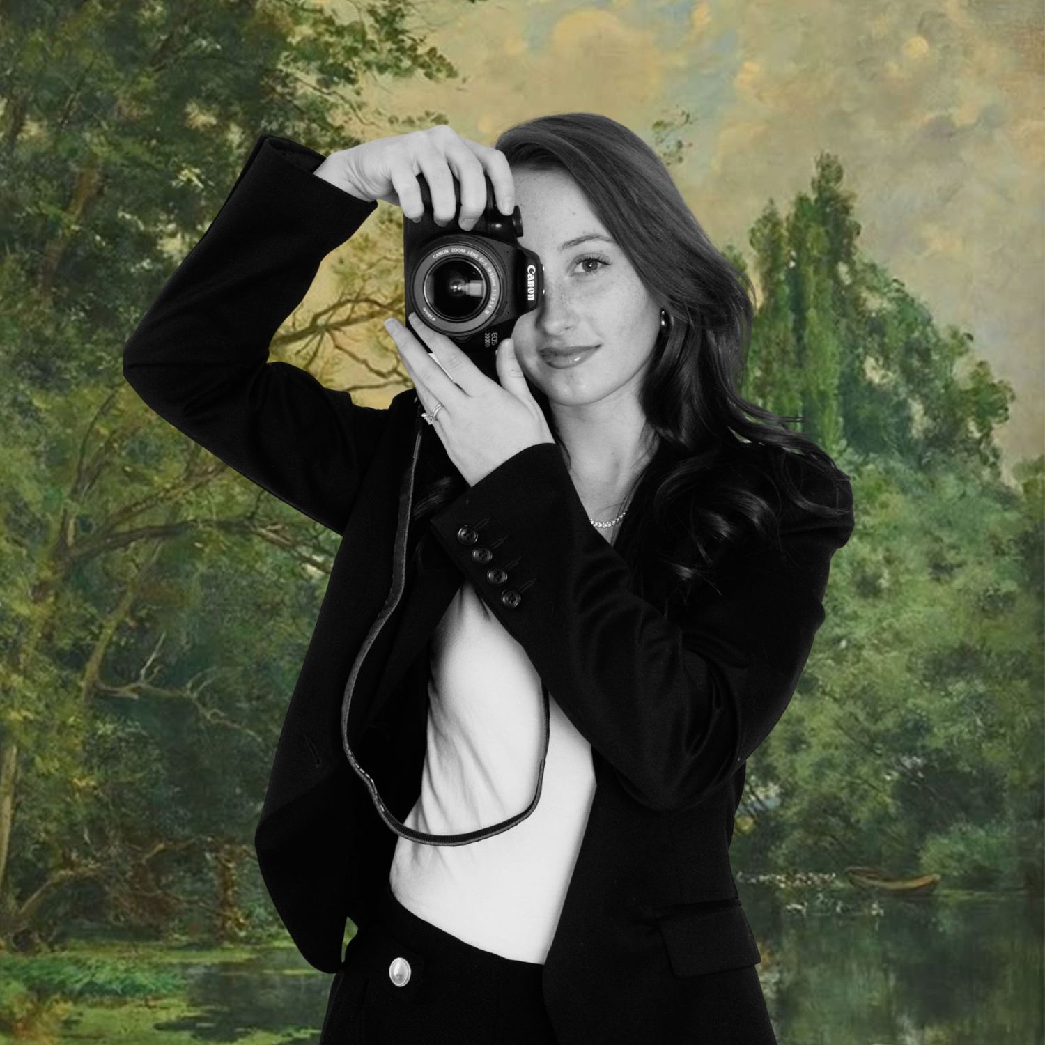 Woman photographer in black blazer holding camera against painted landscape background.