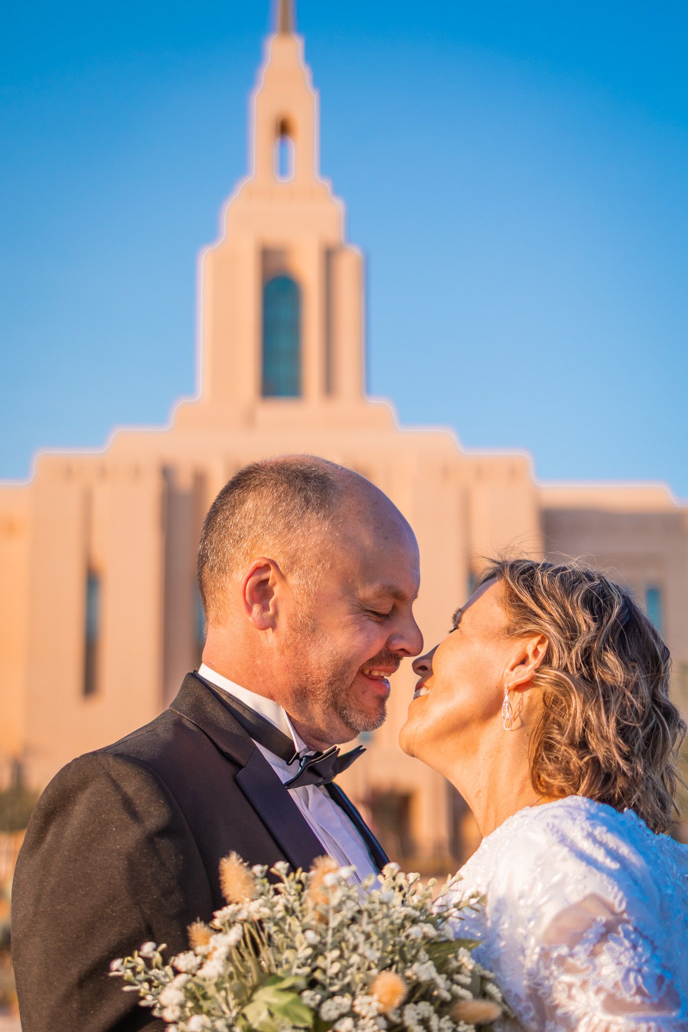 Bridge and Groom in front of Red Cliffs Temple in Utah