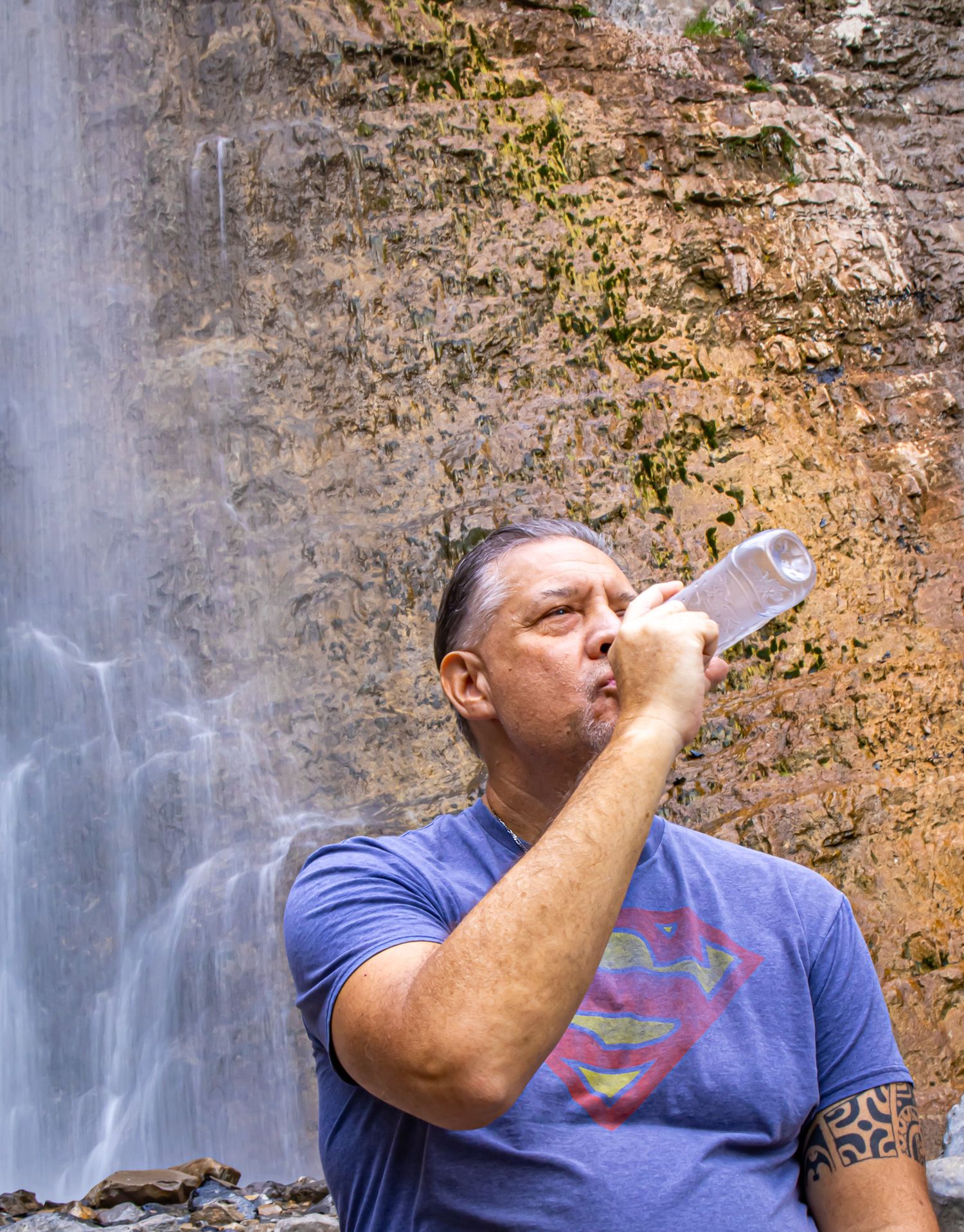 Cool male portrait next to waterfall at Battle Creek Falls in Utah