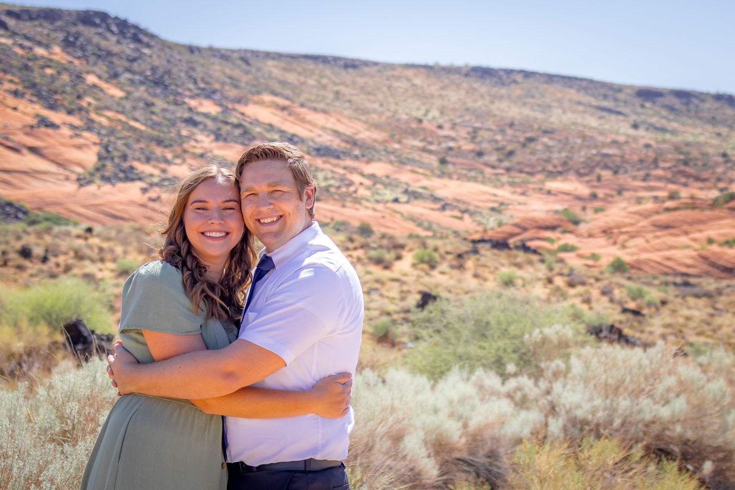 Married couple embracing at Snow Canyon in Utah