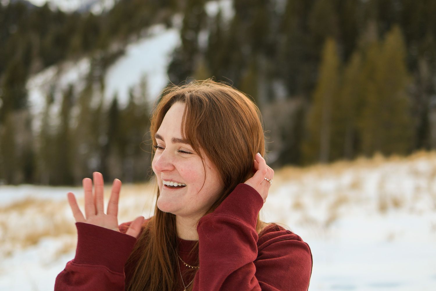 Cute portrait of woman smiling with snow in the background