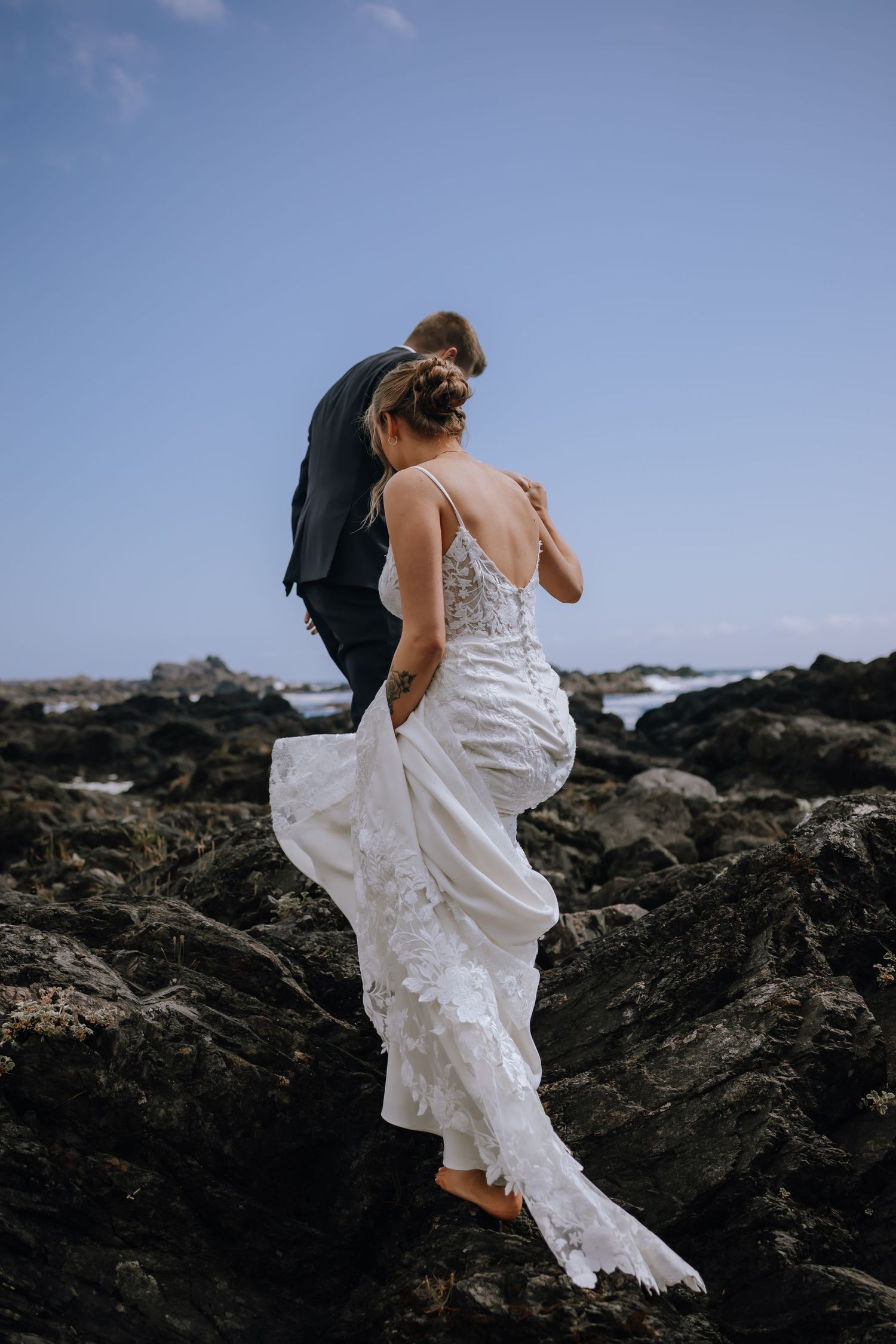 Couple on rocks at the beach outside Black Rock Resort in Ucluelet BC for their elopement