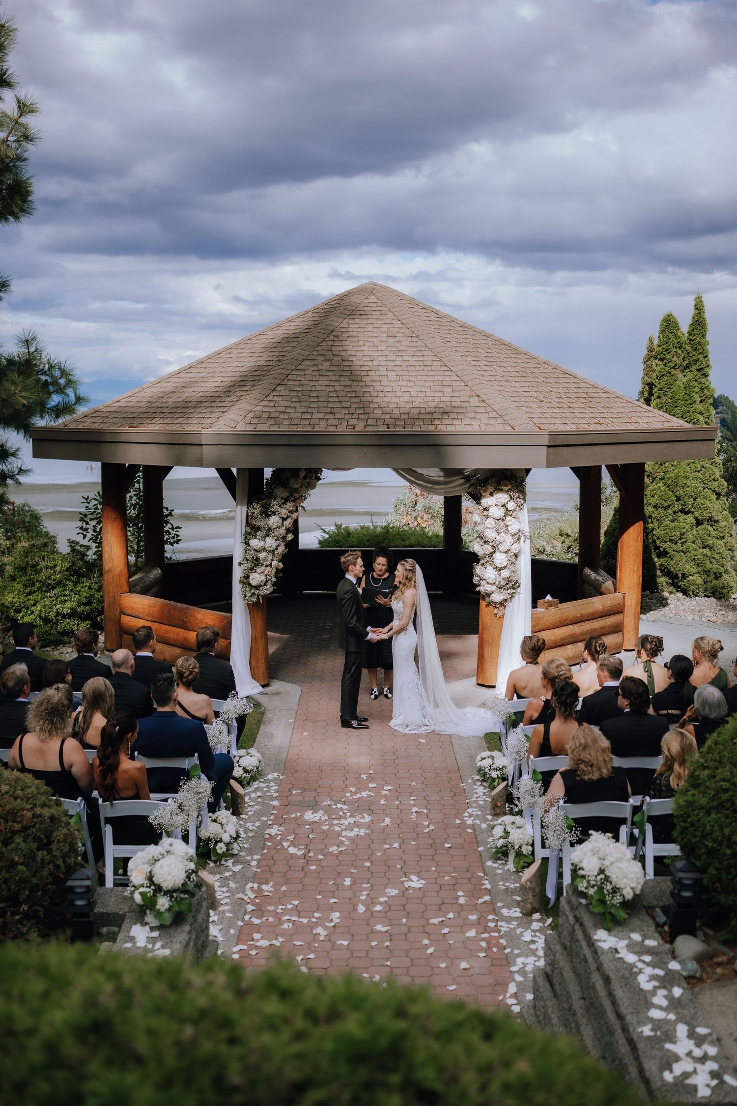 a bride and groom a their summer wedding ceremony at the gazebo at Tigh Na Mara resort and spa in parksville on vancouver island
