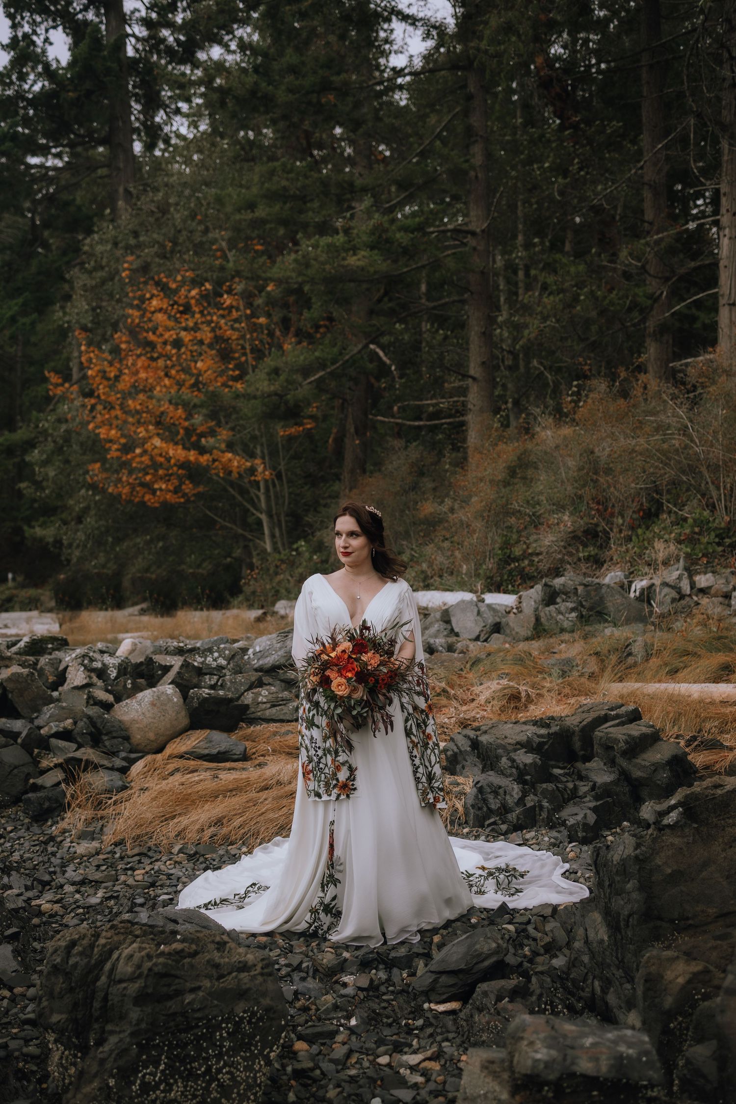 moody oceanside bridal portrait with florals and floral dress