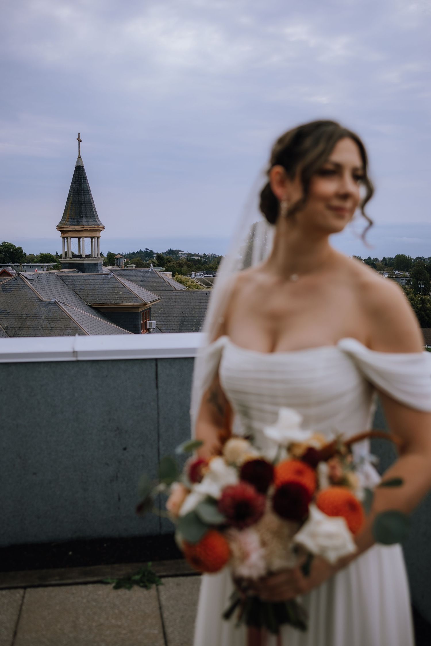 bridal portrait in parkside hotel bridal suite with view of St. Ann's academy