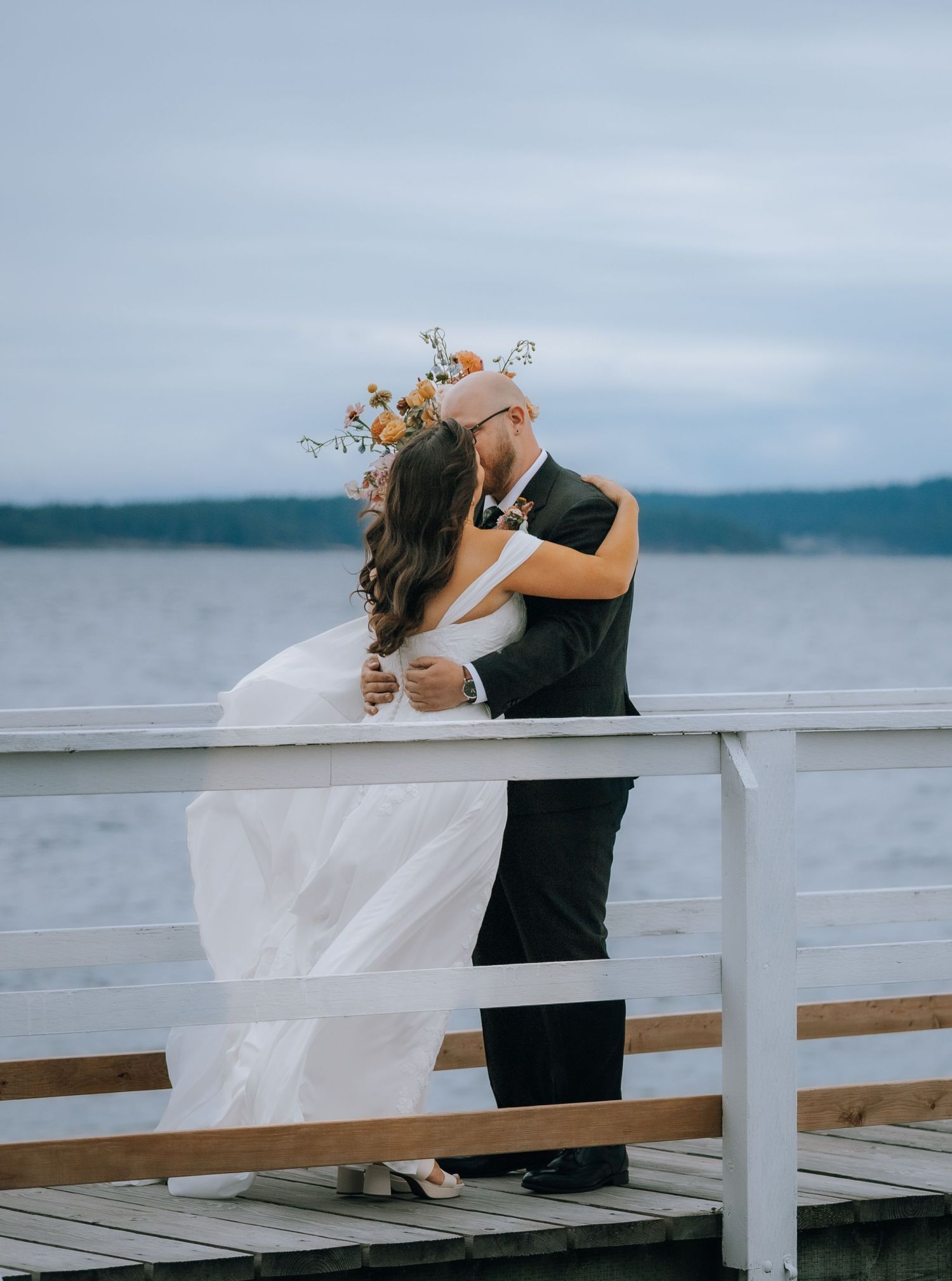 a bride and groom embrace after a first look at inn of the sea in yellow point, Nanaimo on vancouver island preparing for their wedding