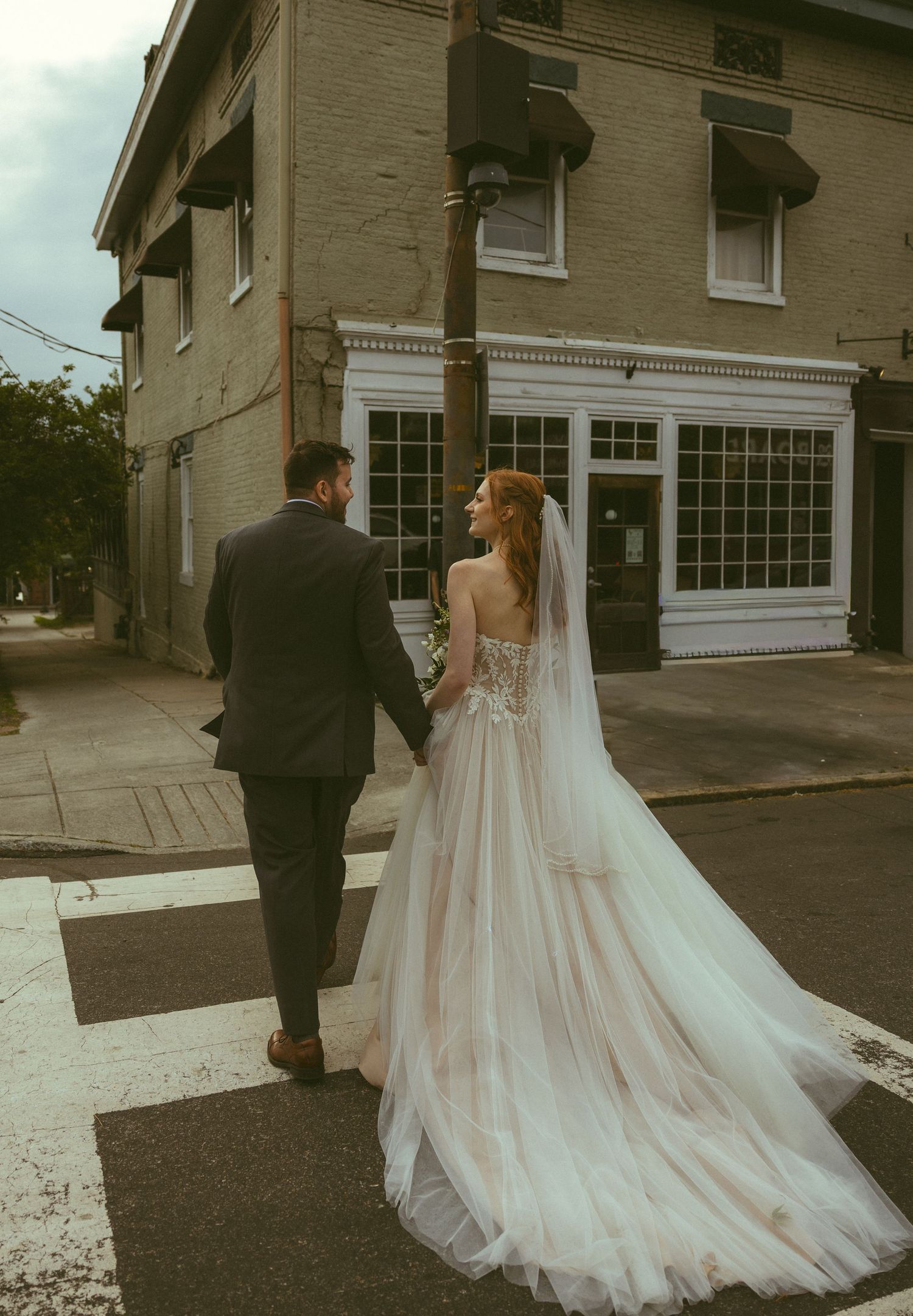 Bride and groom embracing downtown in Wilmington North Carolina.