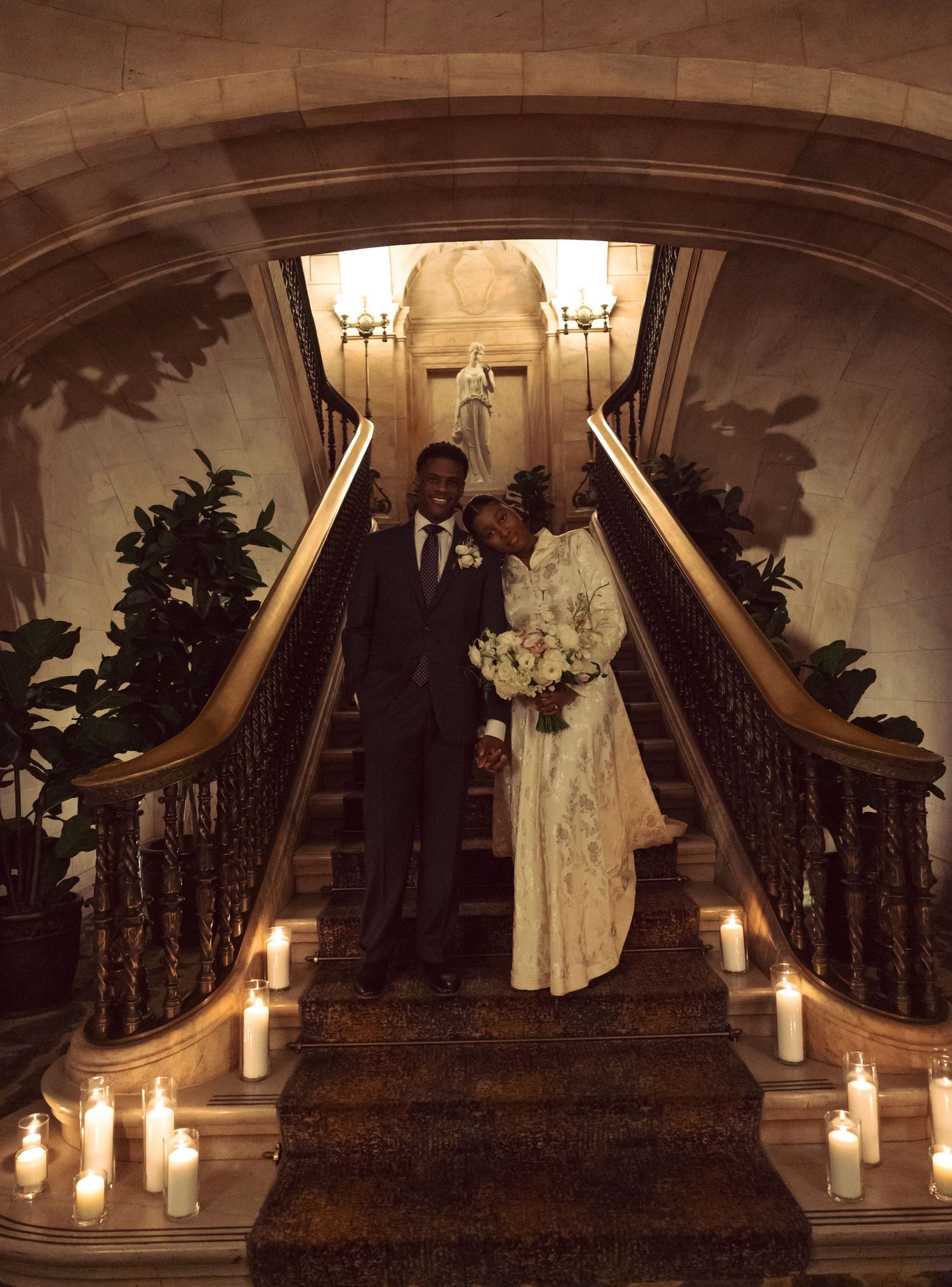 Bride standing on a grand staircase during a cinematic Ohio wedding.