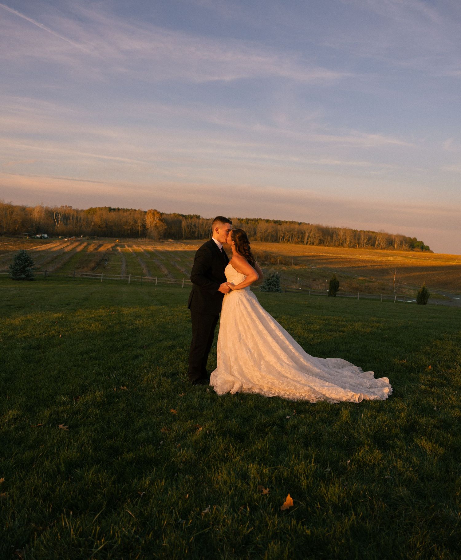 Bride and groom embracing during sunset portraits in Ohio, captured by Allison Hull Photography.