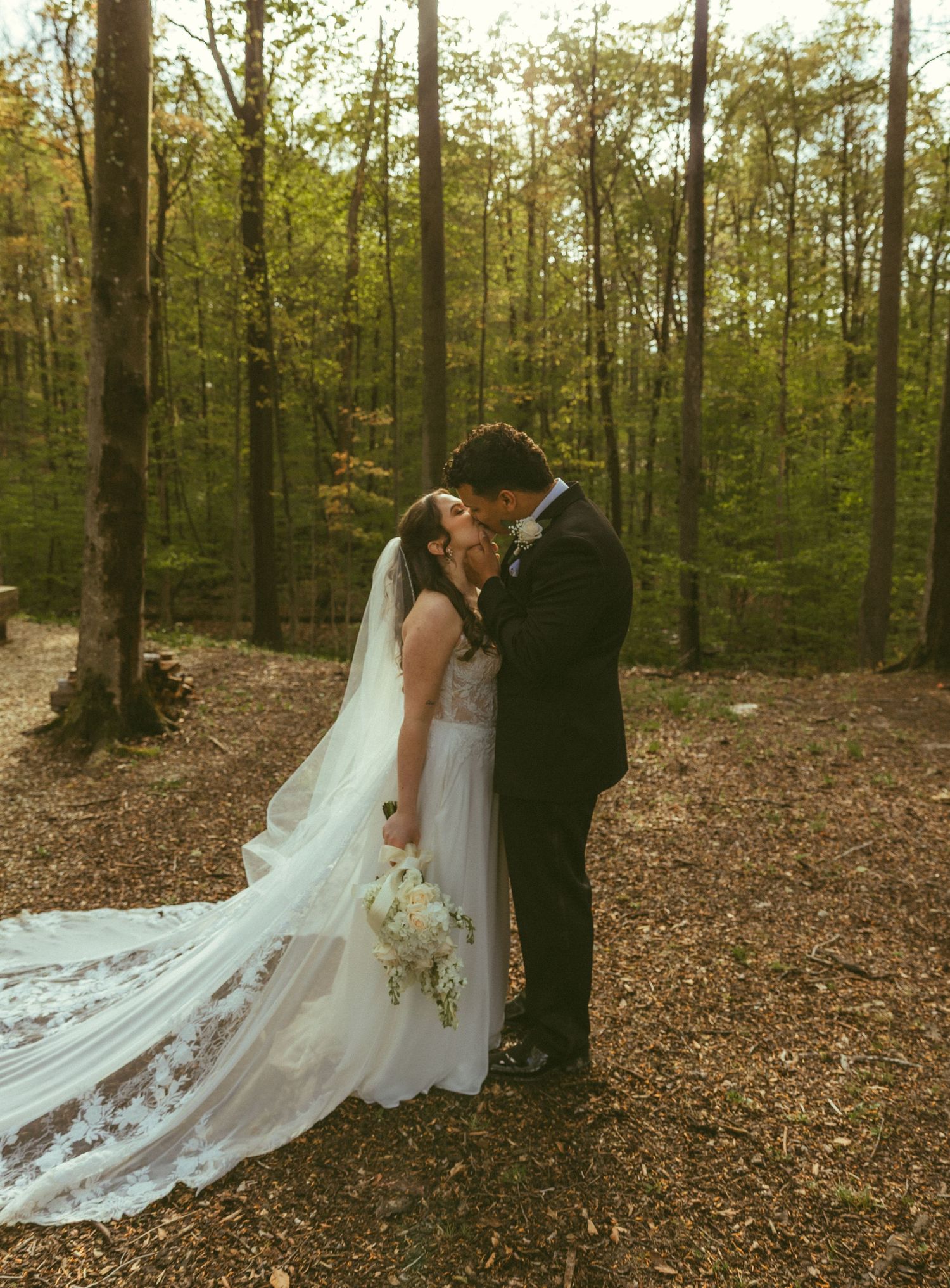Bride and groom embracing in a forest during their Ohio wedding ceremony.