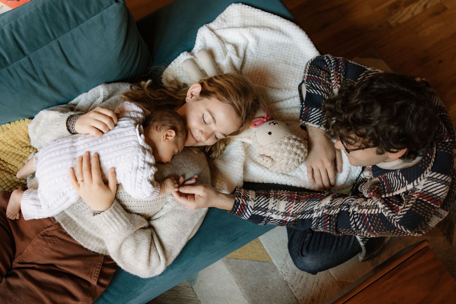 A cozy family moment of relaxation and bonding on a plush sofa.