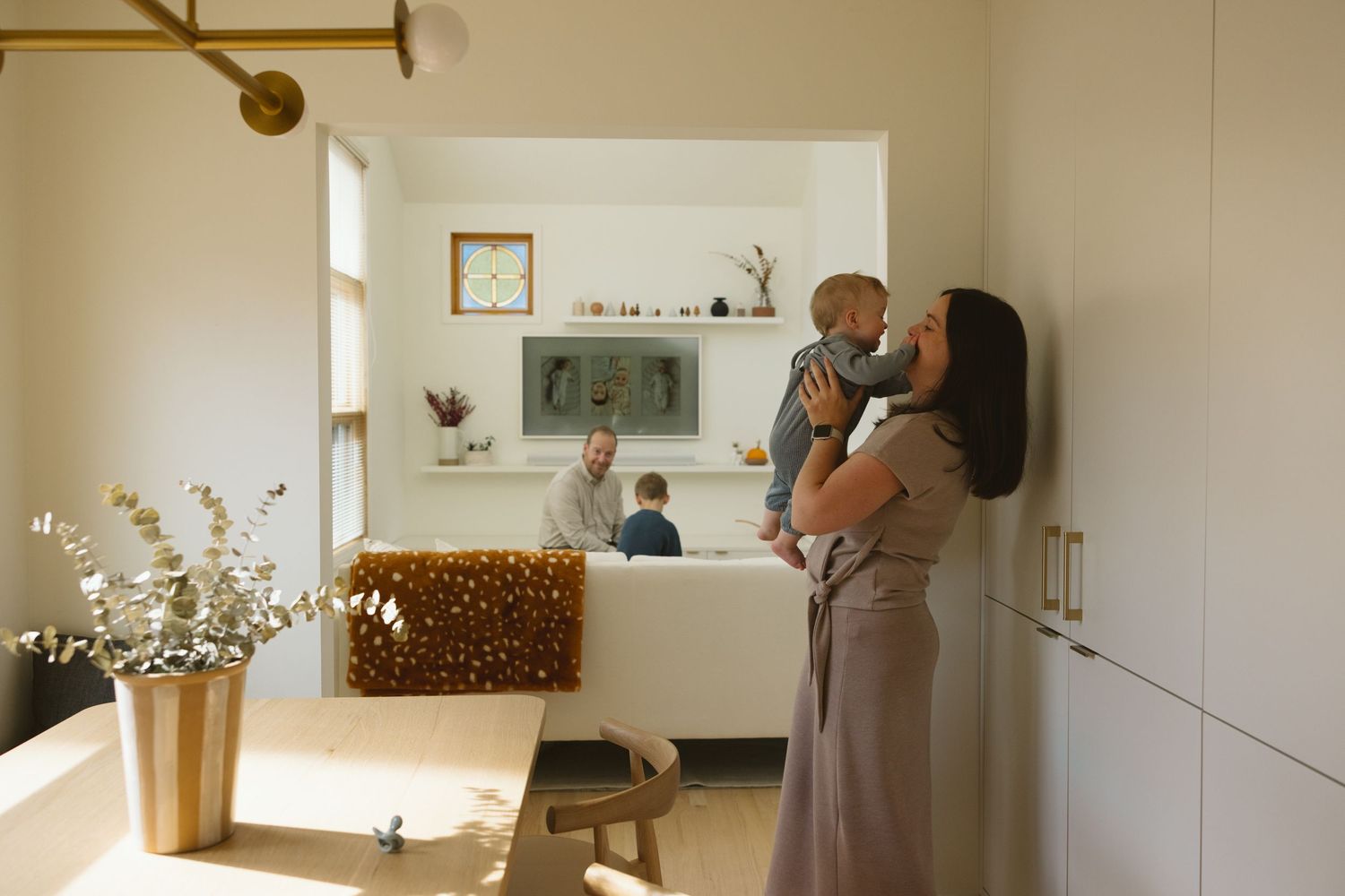 Four side-by-side images showing a nursery design process from empty room to finished baby room with star decor.