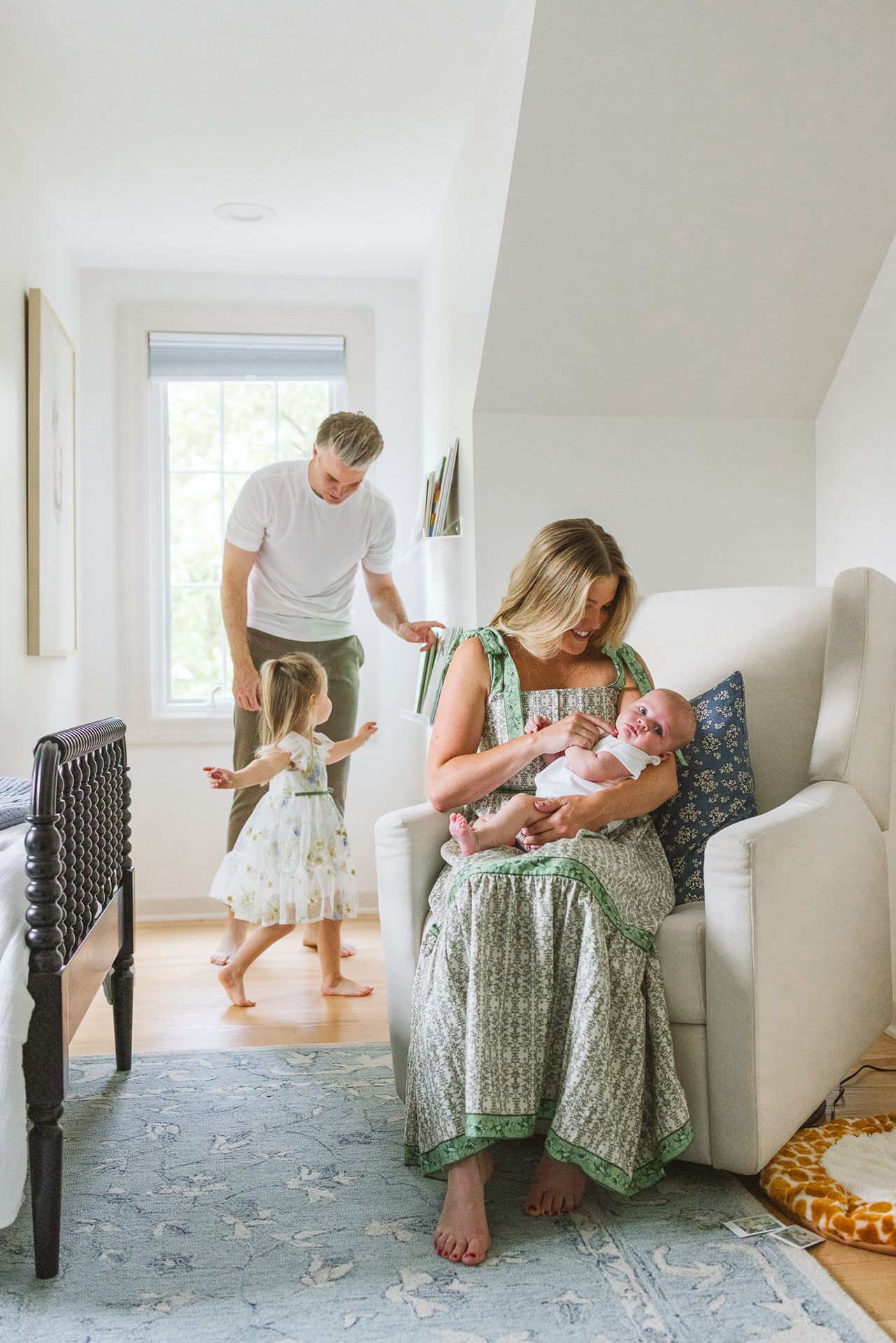 A tender family scene in a bright home with a newborn and toddler.