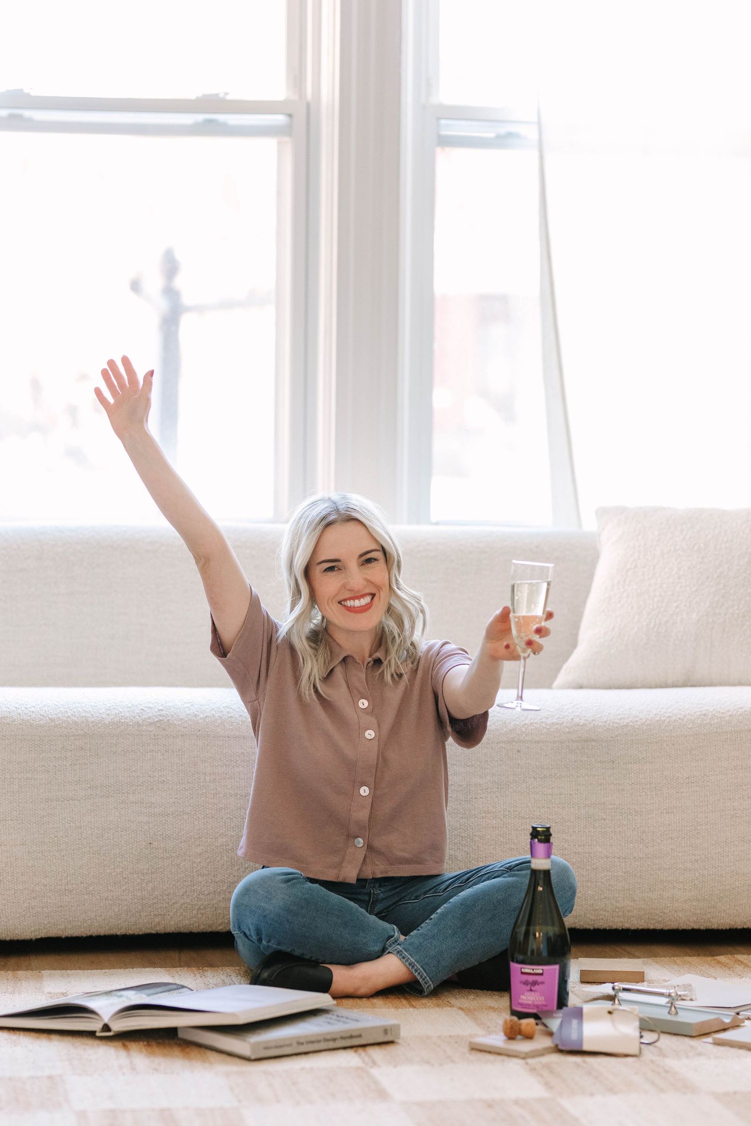 Casual lifestyle photos showing joyful moments with books and drinks on white floor.
