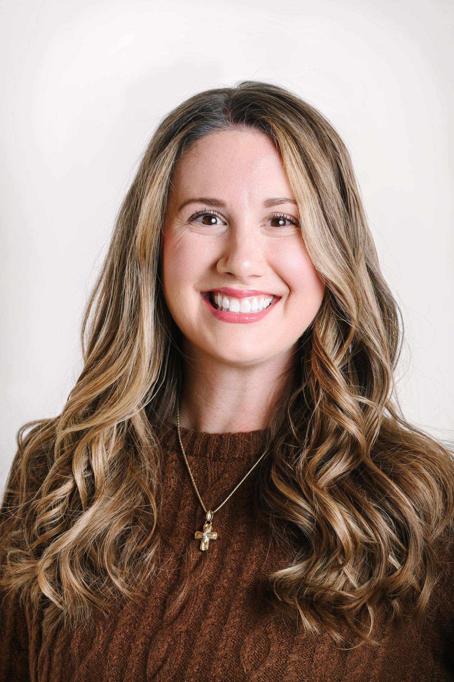 Professional headshot series showing warm smile and wavy brown hair against white background.