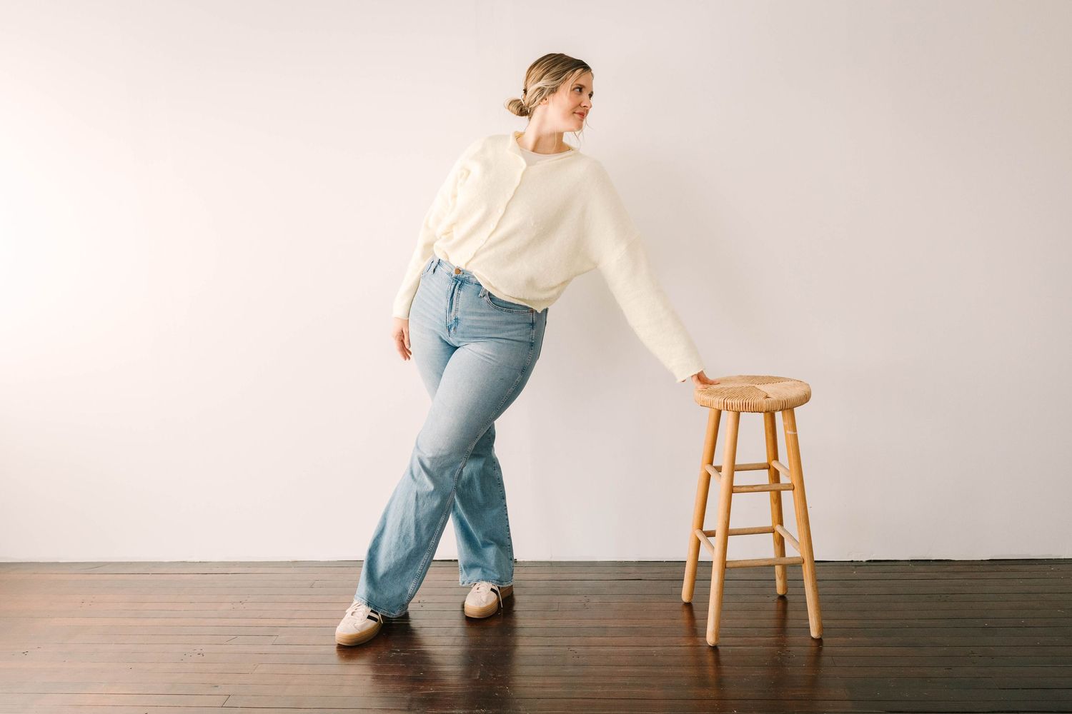 Minimalist studio photos with wooden stool against white background showing movement.