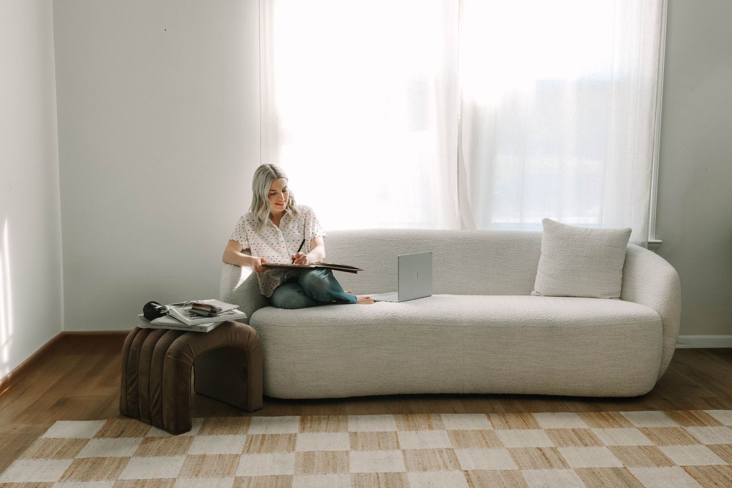 Minimalist interior scene with white sofa and natural lighting creating a serene atmosphere.
