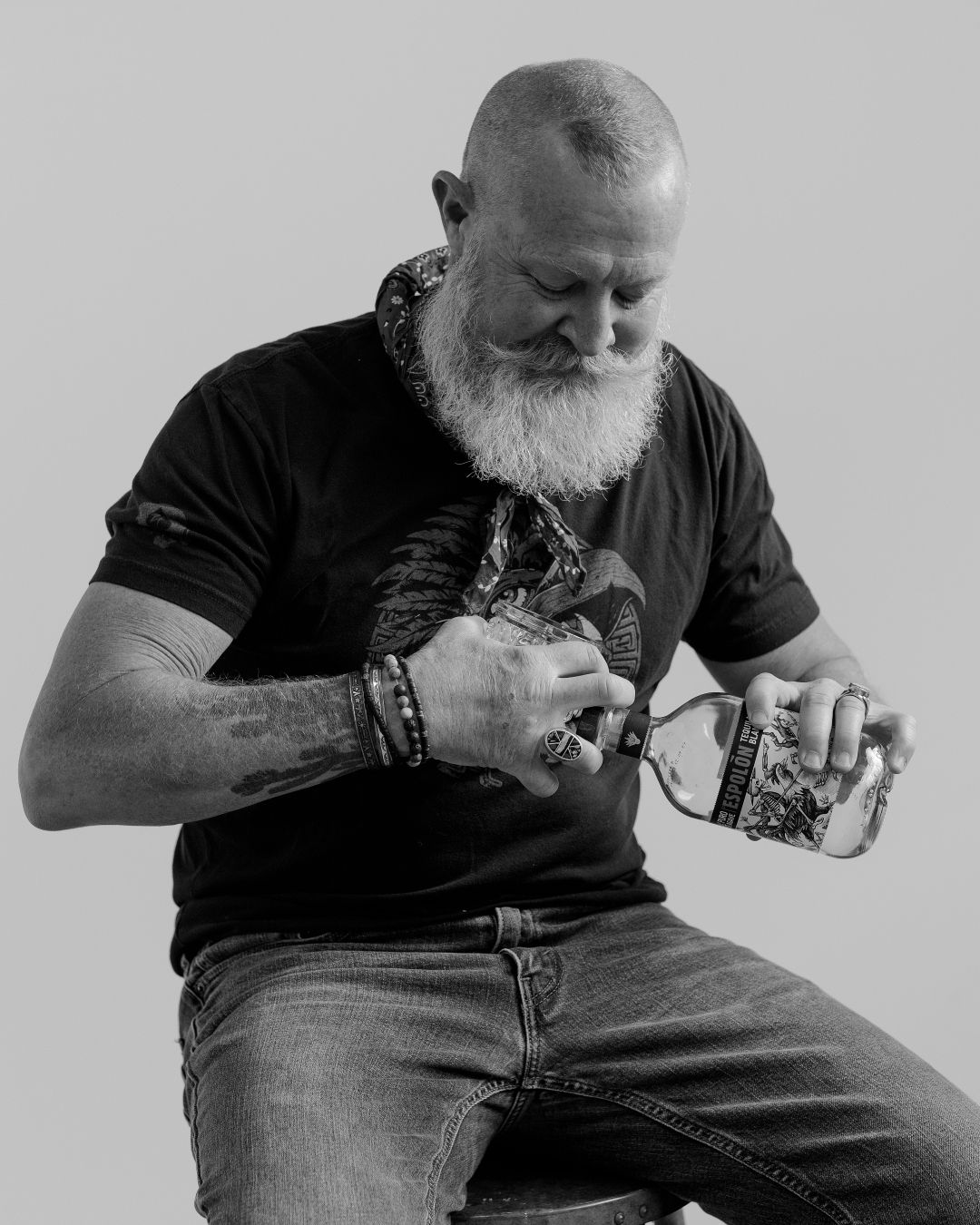 Black and white sequence of someone in dark clothing examining an object.