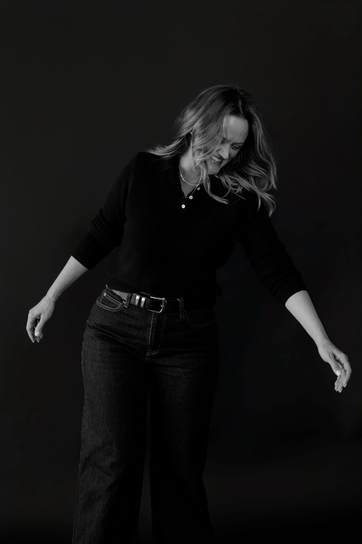 Dramatic monochrome series showing playful poses in casual black attire.