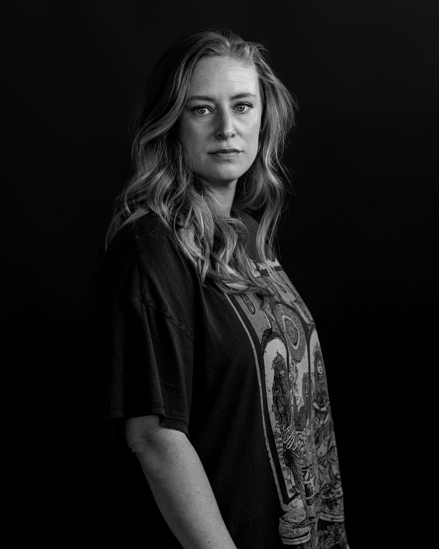 Dramatic black and white portraits with graphic t-shirt and natural expressions.