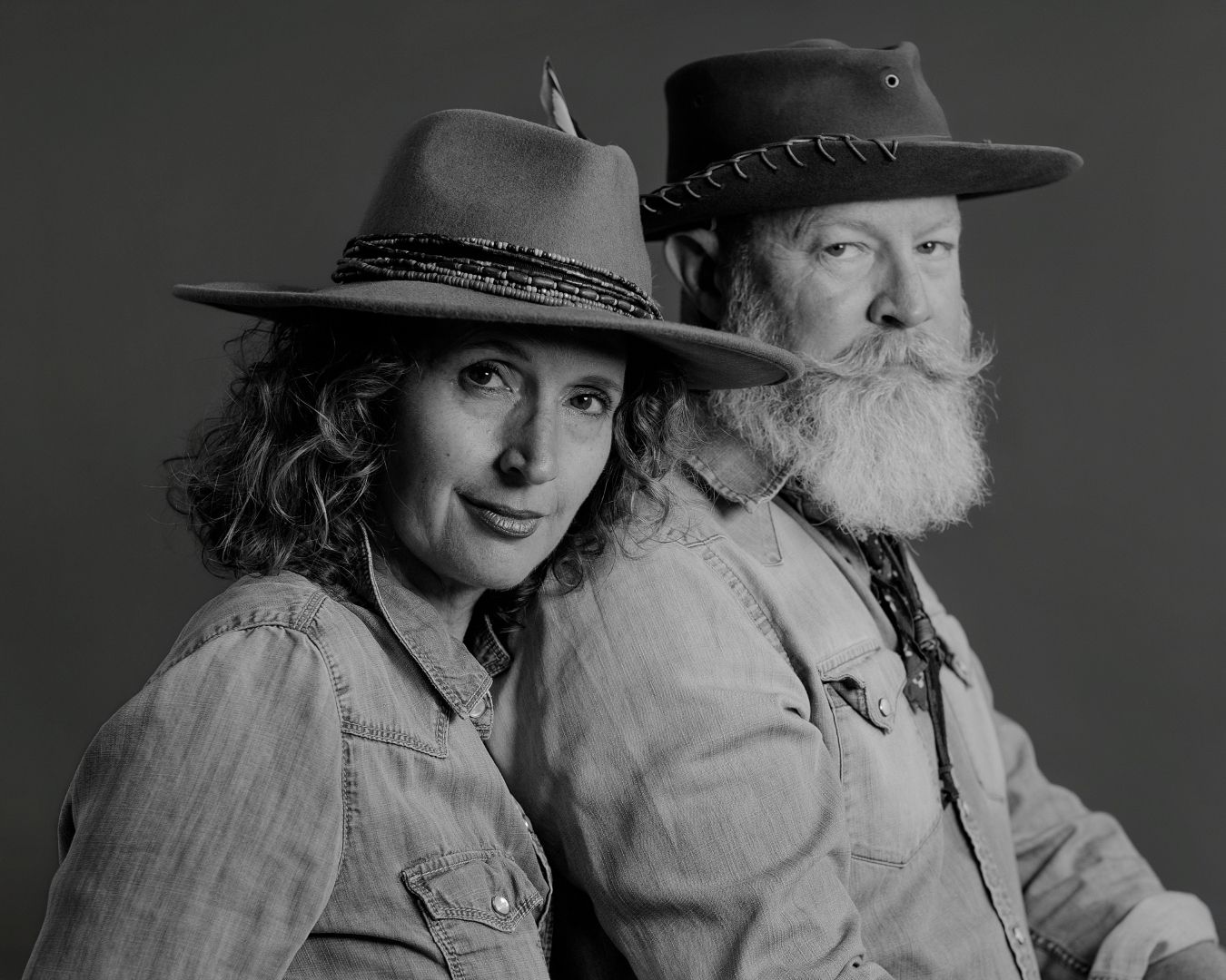 Western-themed black and white photo series featuring couple in denim and hats.