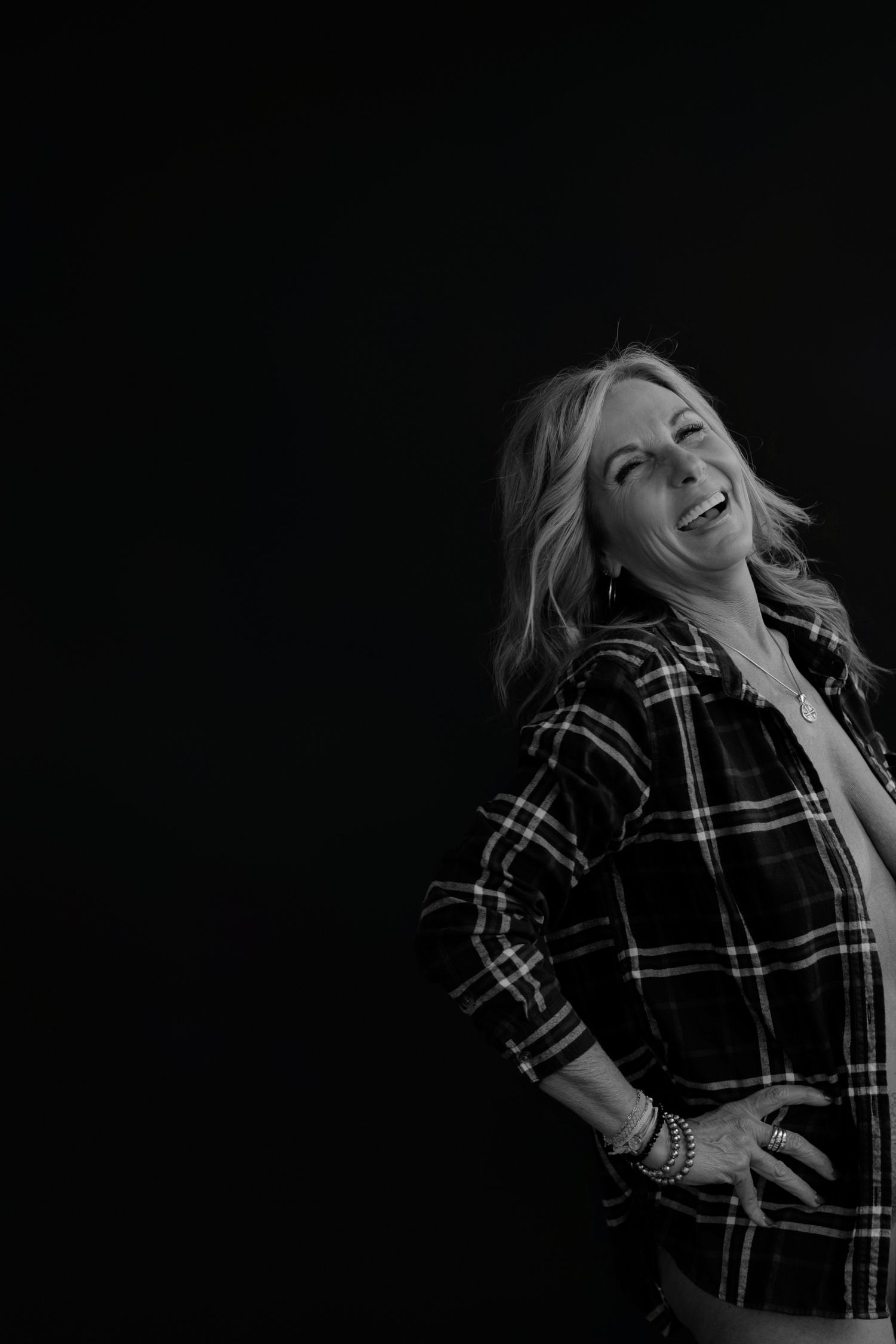 Dramatic black and white photos showing joyful expressions in plaid shirt.