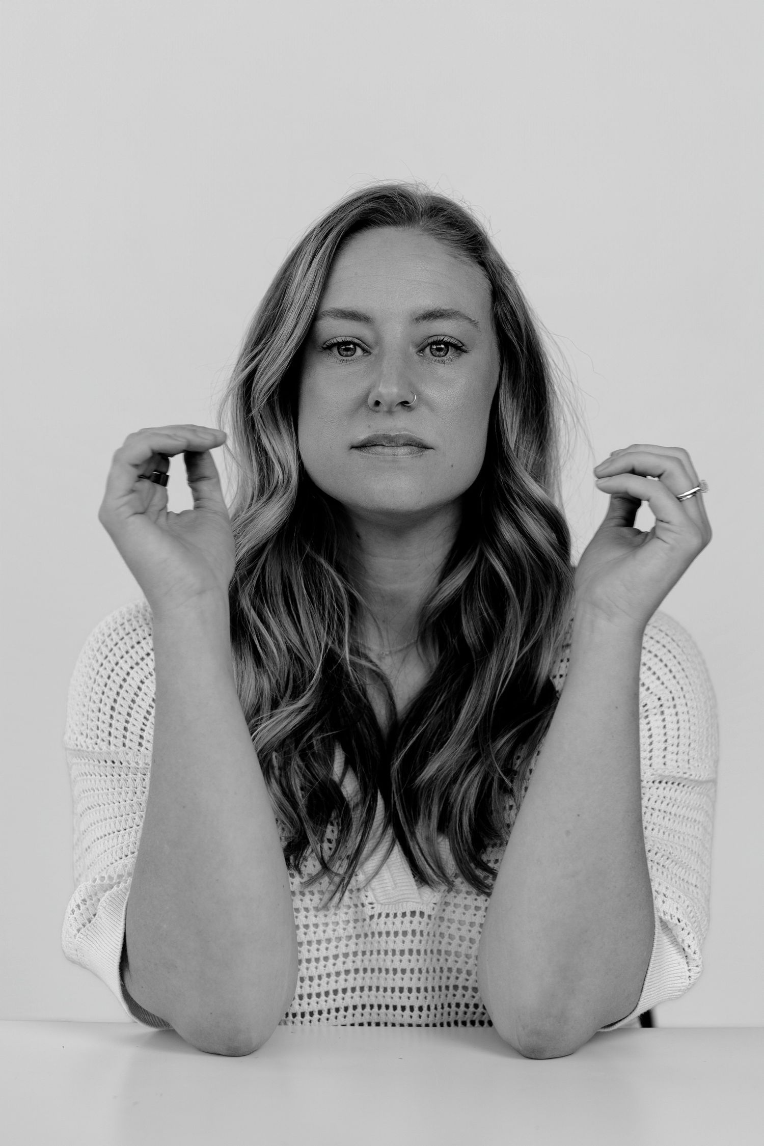 Person in white top demonstrating various poses and expressions in studio setting.
