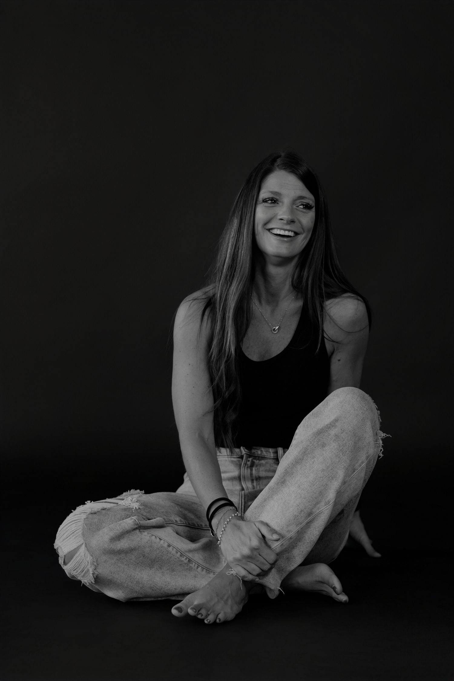 Casual seated poses on floor showing relaxed comfort in black and white.