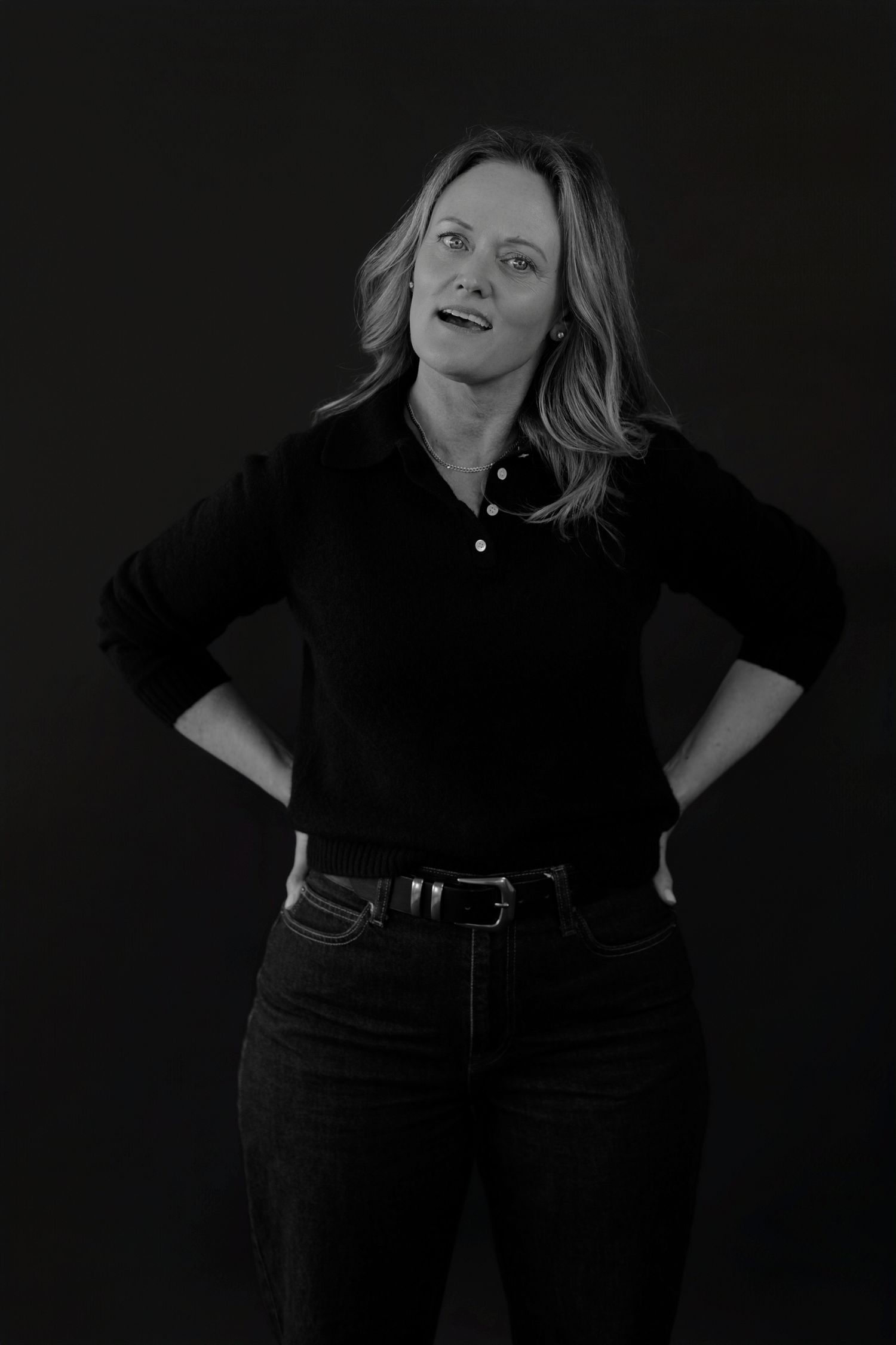 Dynamic black and white photographs of figure in all-black outfit showing different poses.