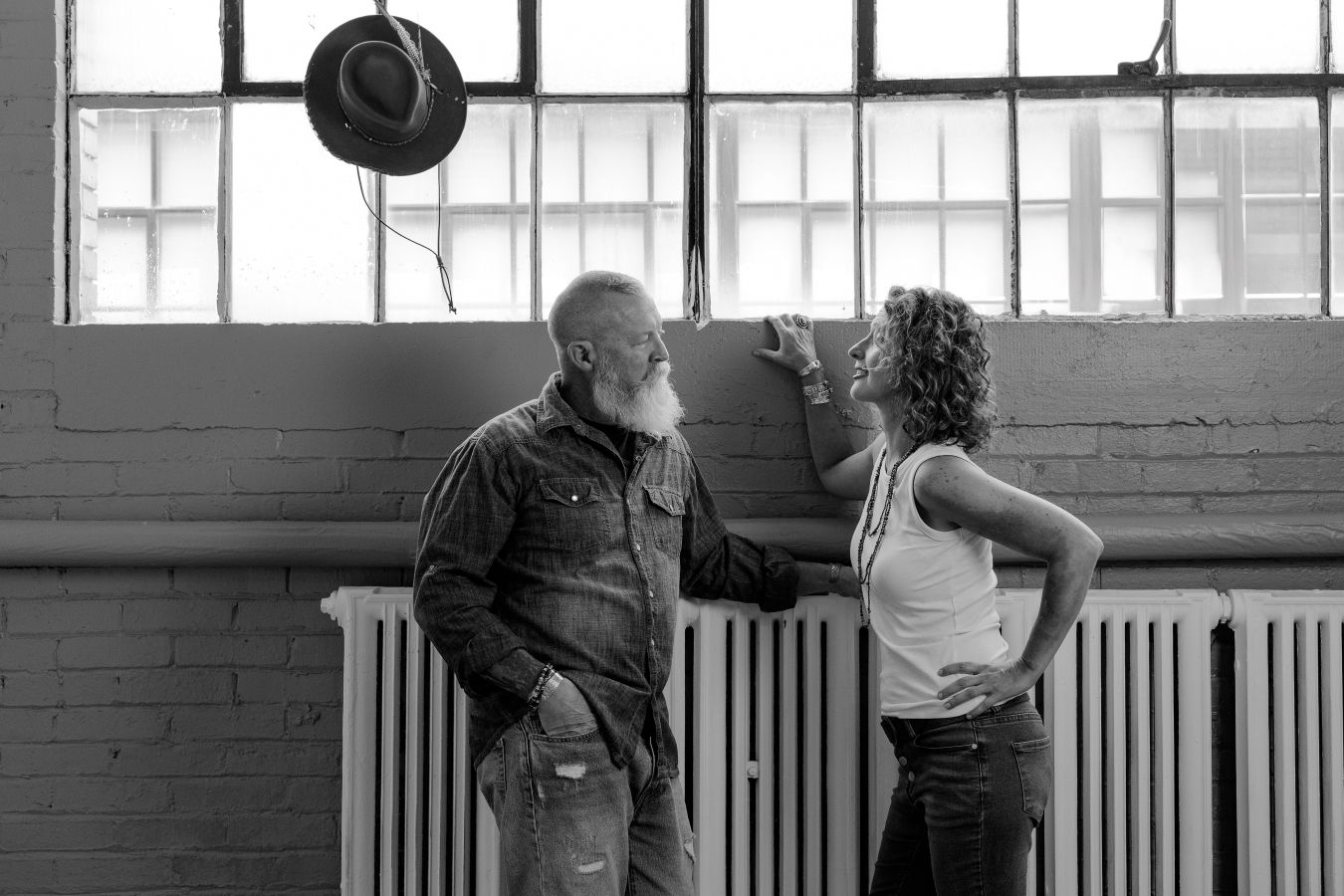 Studio dance sequence with window backdrop showing two people in coordinated movement.