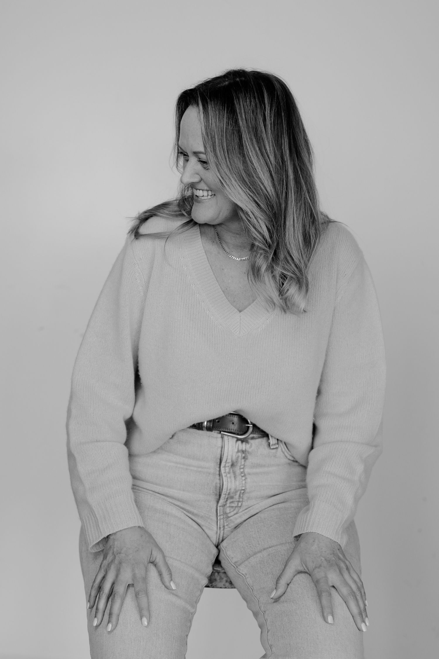 Artistic black and white portraits showing playful poses in casual attire.
